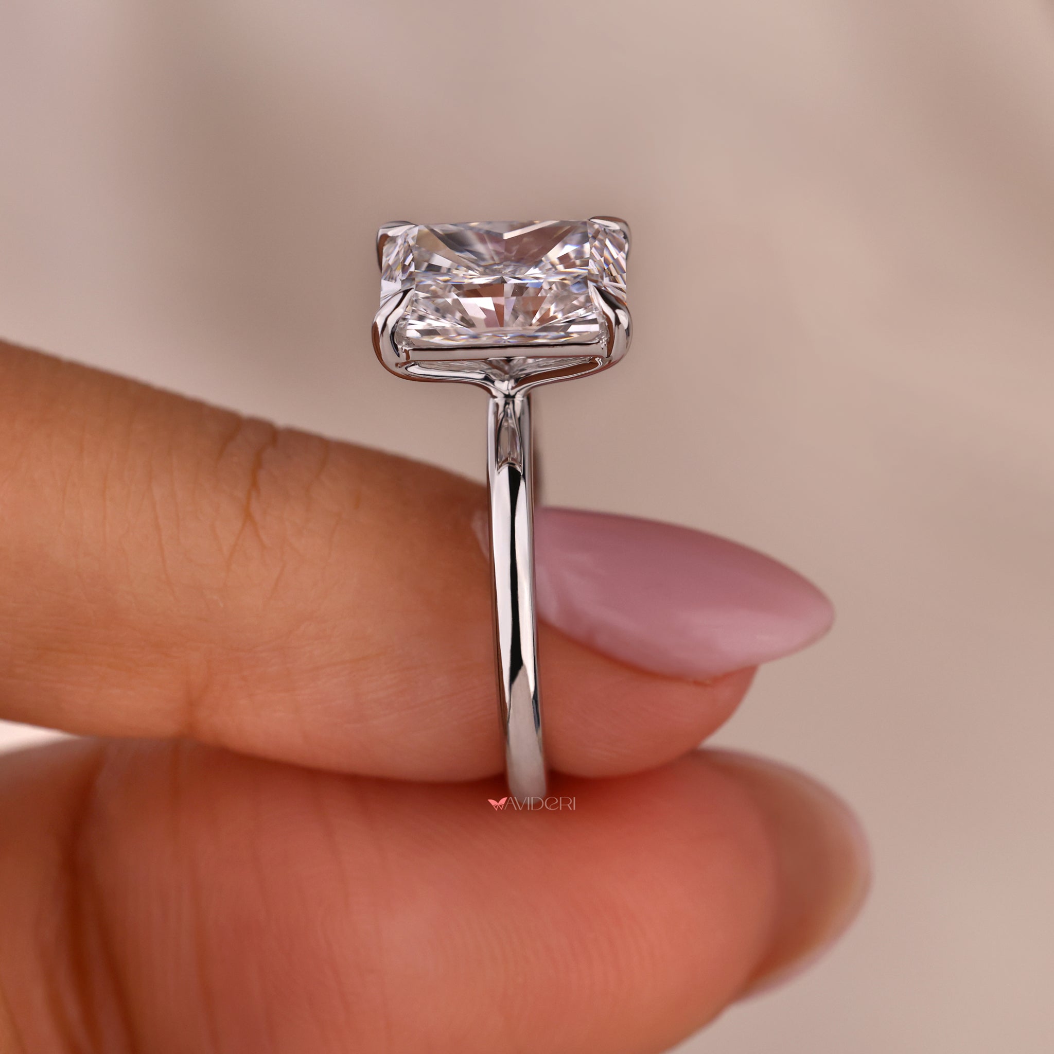 Elegant solitaire engagement ring with a radiant diamond centerpiece.