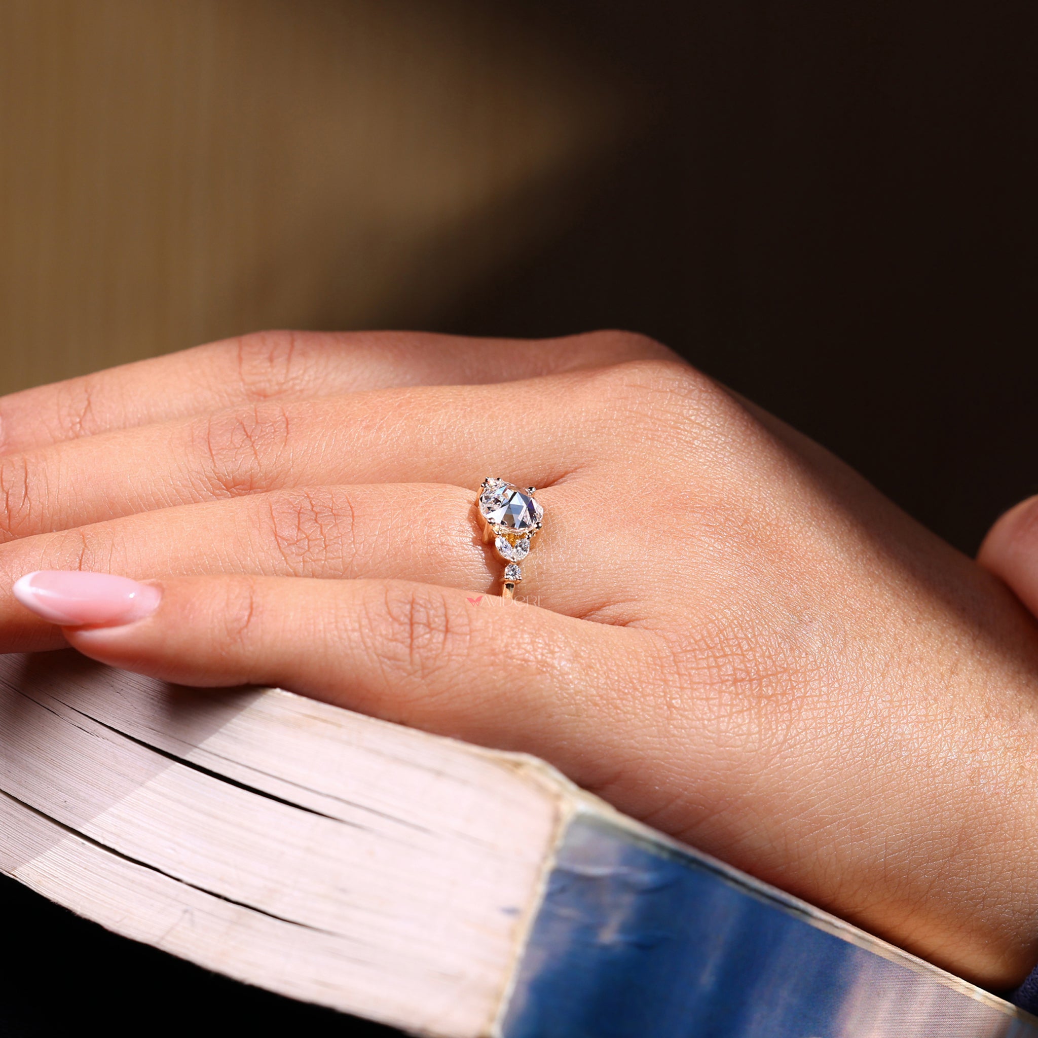 Marquise cut diamond ring featuring a delicate rose cut diamond.