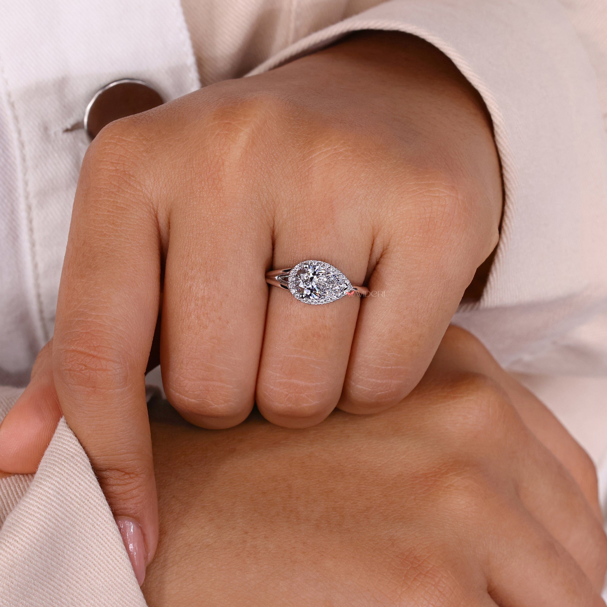 Round cut diamond ring with an engagement ring halo.