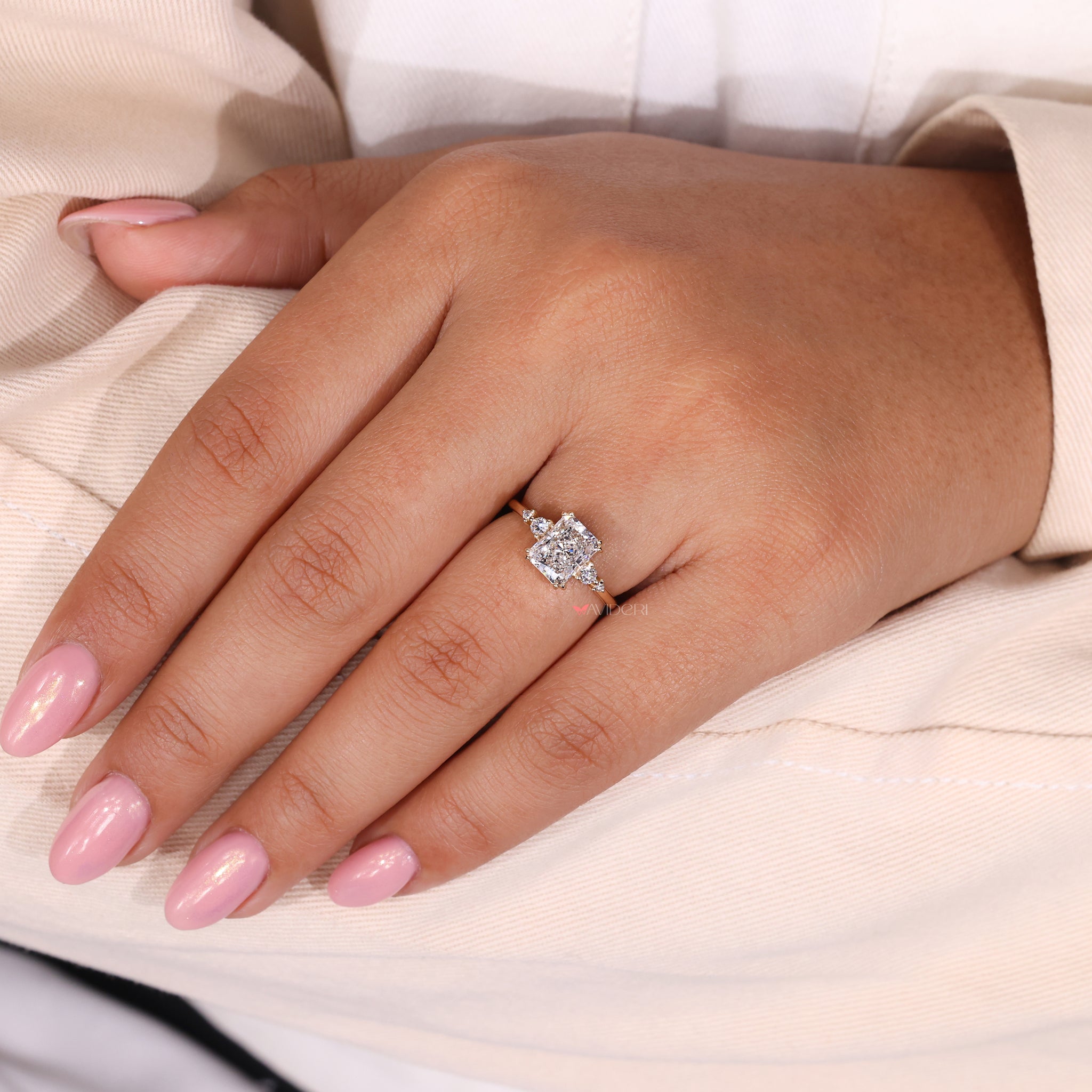 Double prong ring featuring a radiant cut diamond for secure brilliance.