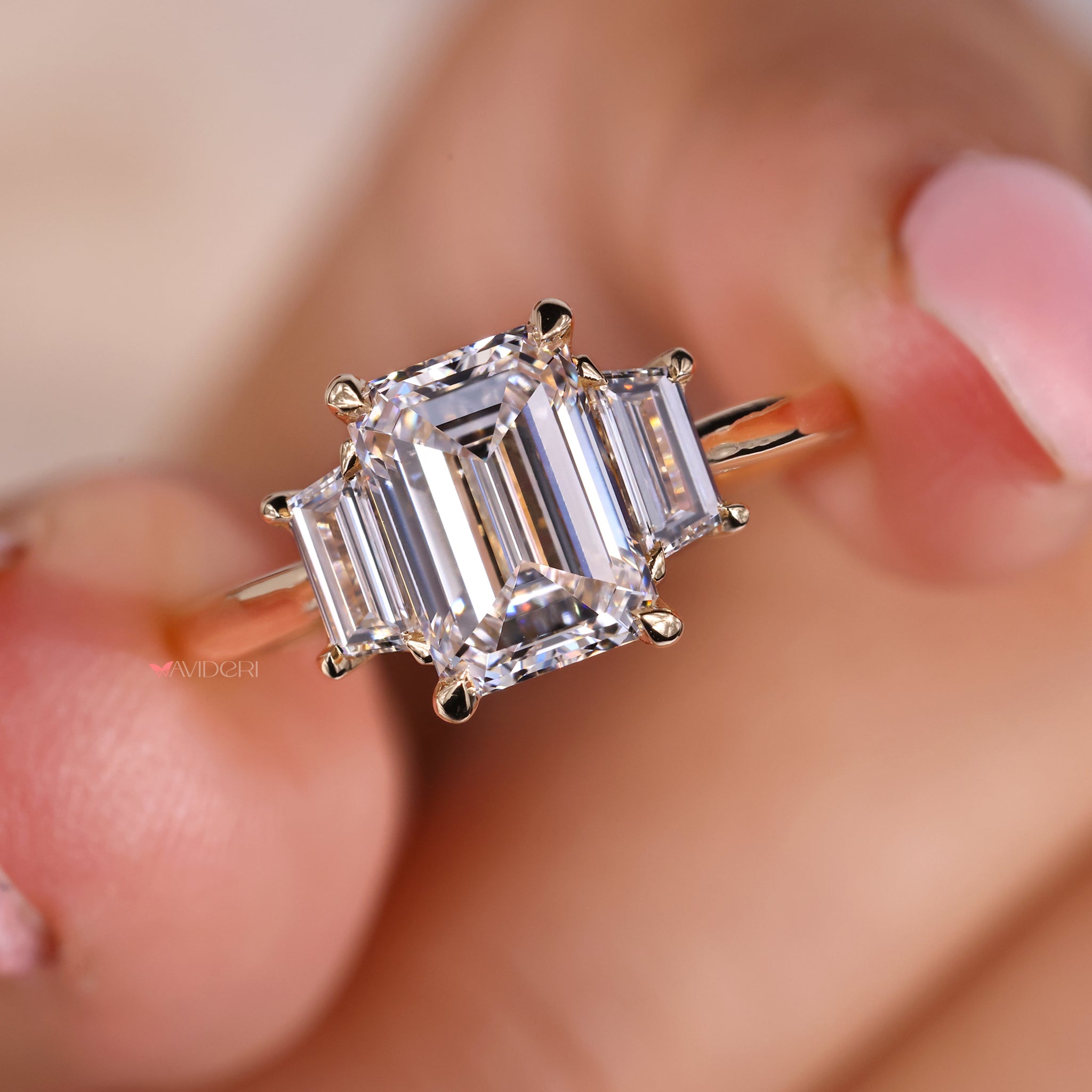 Three stone wedding ring with emerald cut diamond set in a gold solitaire ring