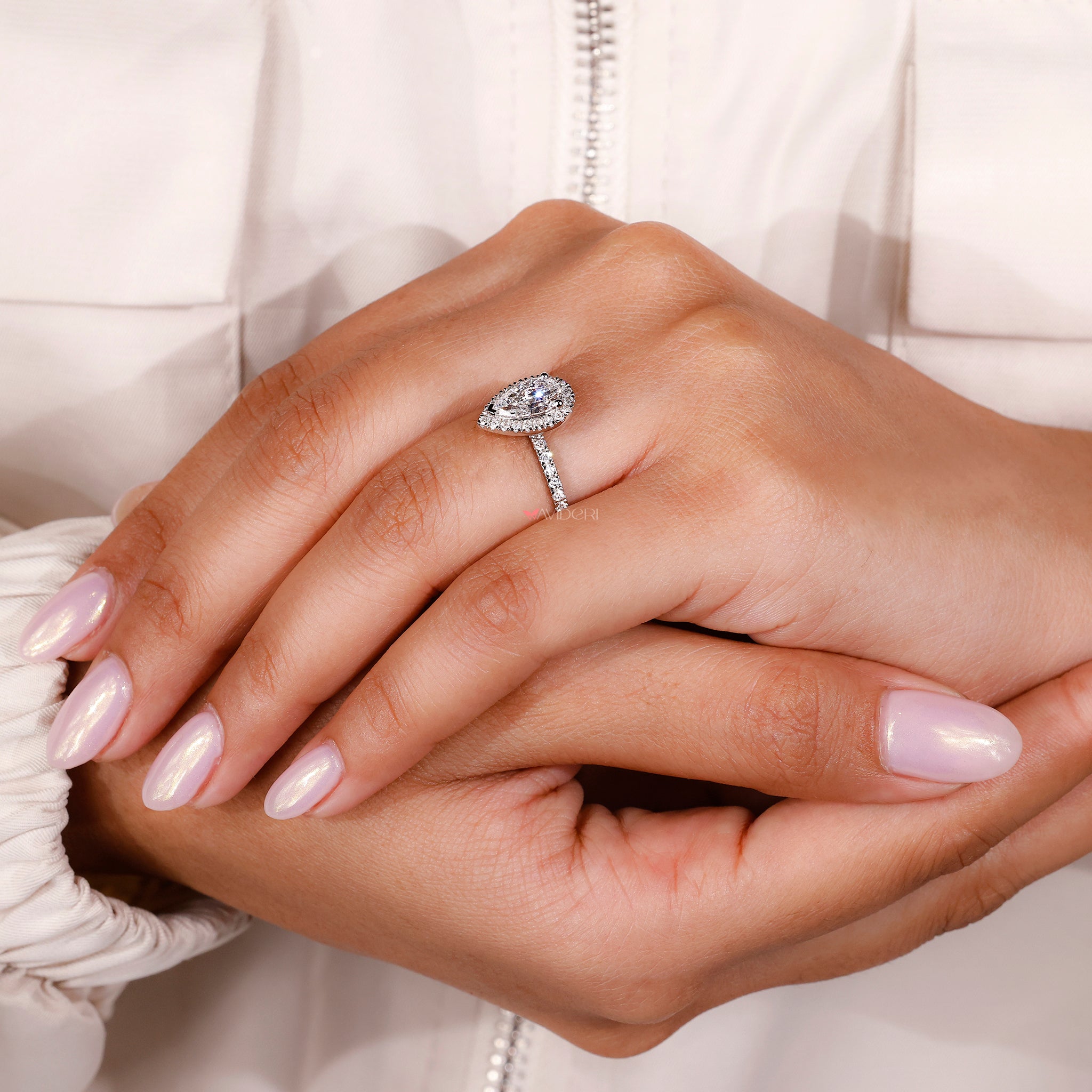 Lab grown diamond engagement ring with halo setting.