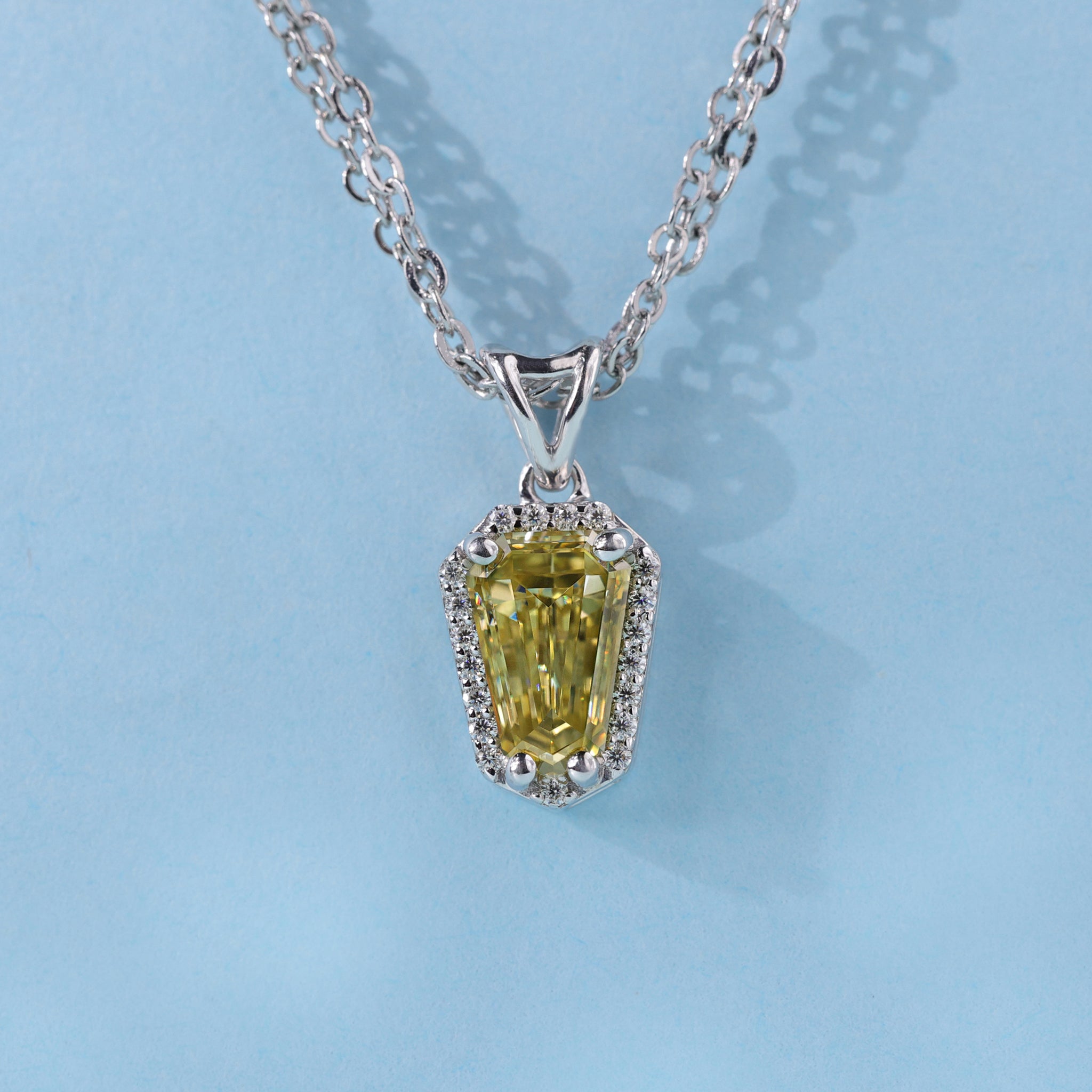 Shield cut moissanite pendant highlights sharp beauty with detailed craftsmanship.