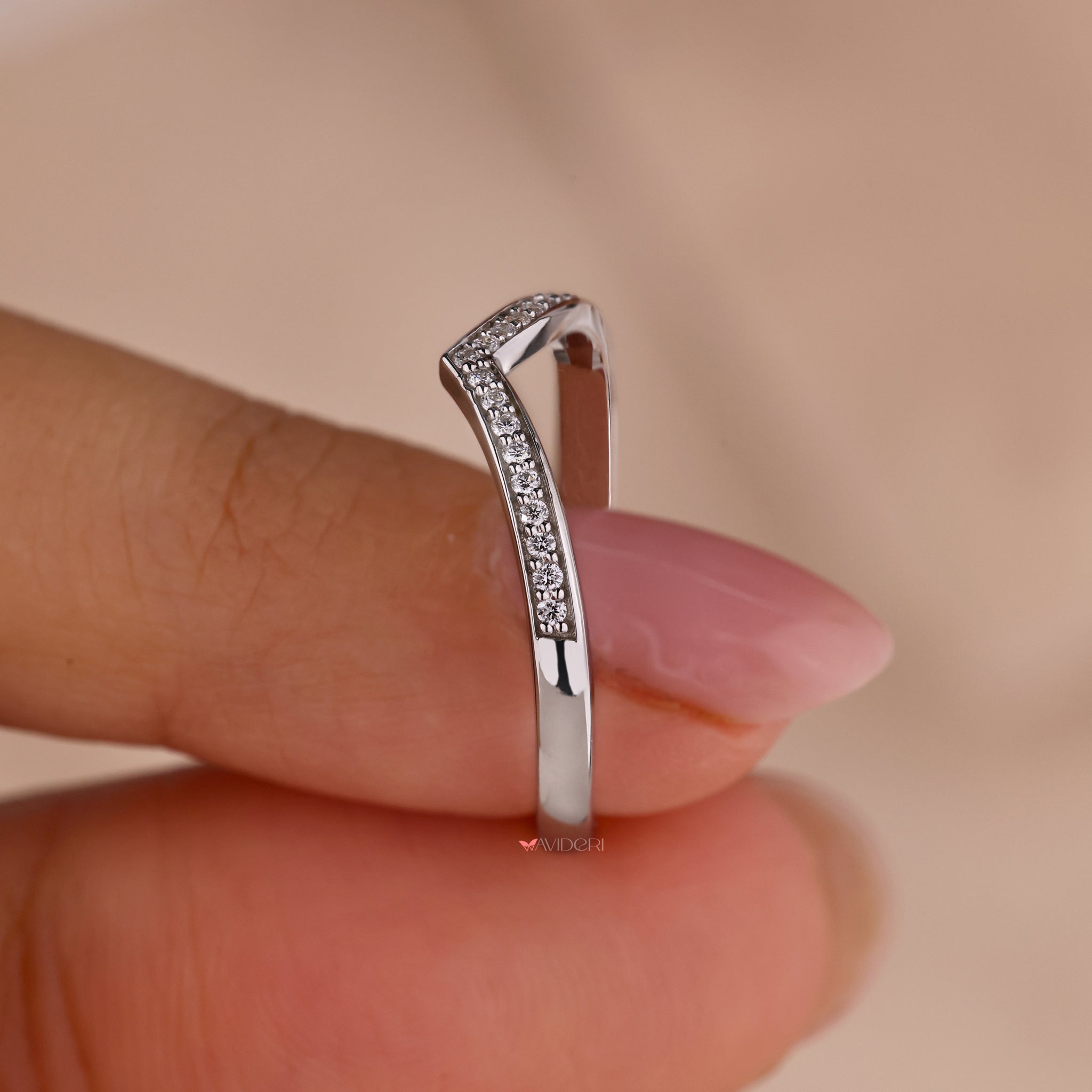 Diamond and white gold wedding band with intricate details.
