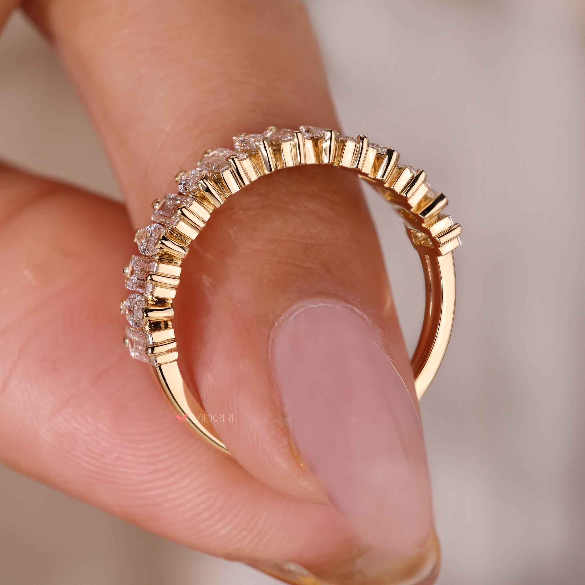 Yellow gold diamond band in a two-prong setting.