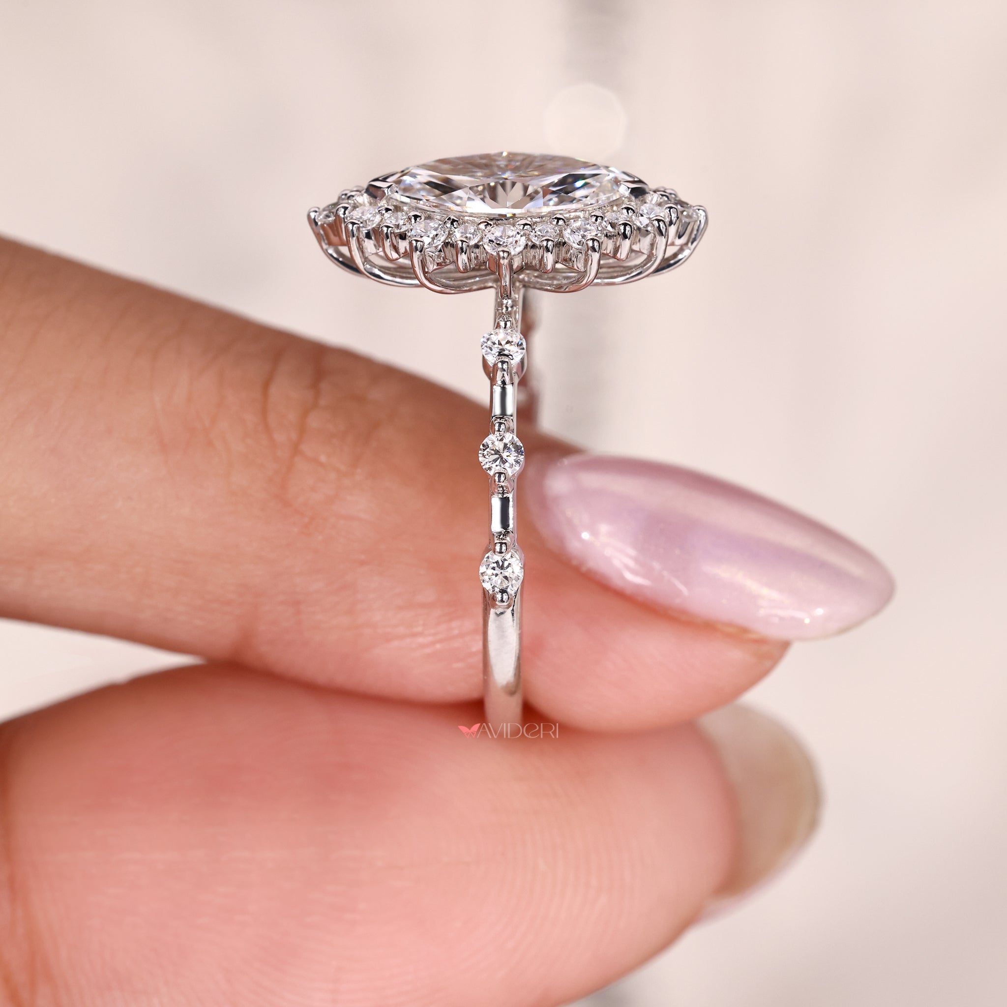 round cut halo engagement ring with lab grown diamonds and distance pave band.