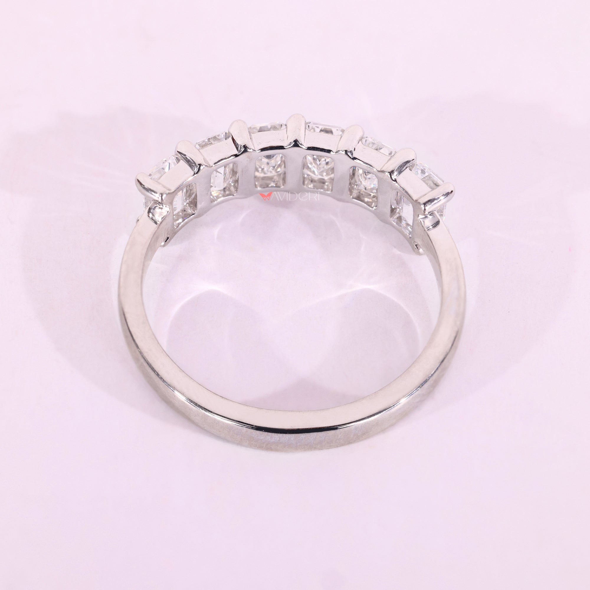 White gold wedding band with emerald cut diamonds.