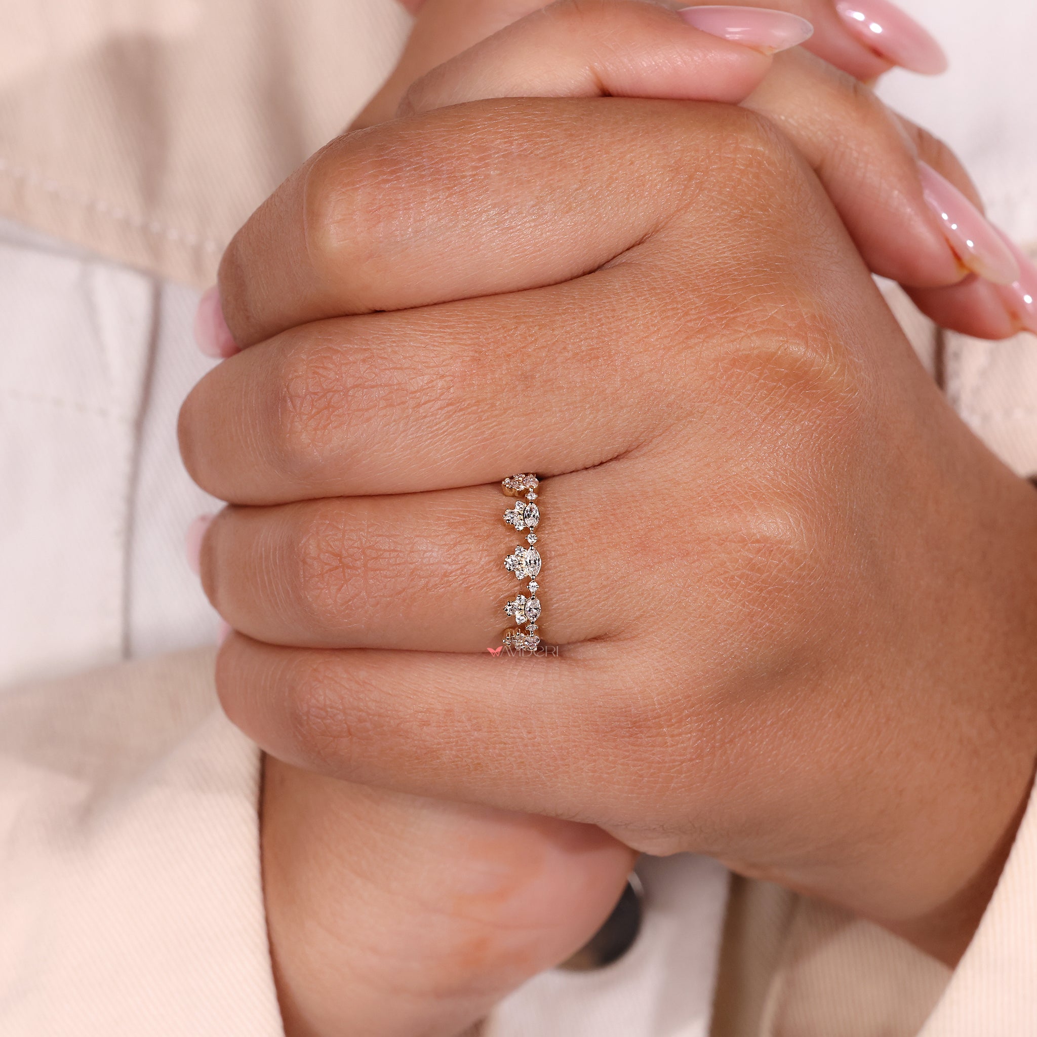 Yellow gold wedding band featuring marquise cut diamonds and a crown-inspired curve.