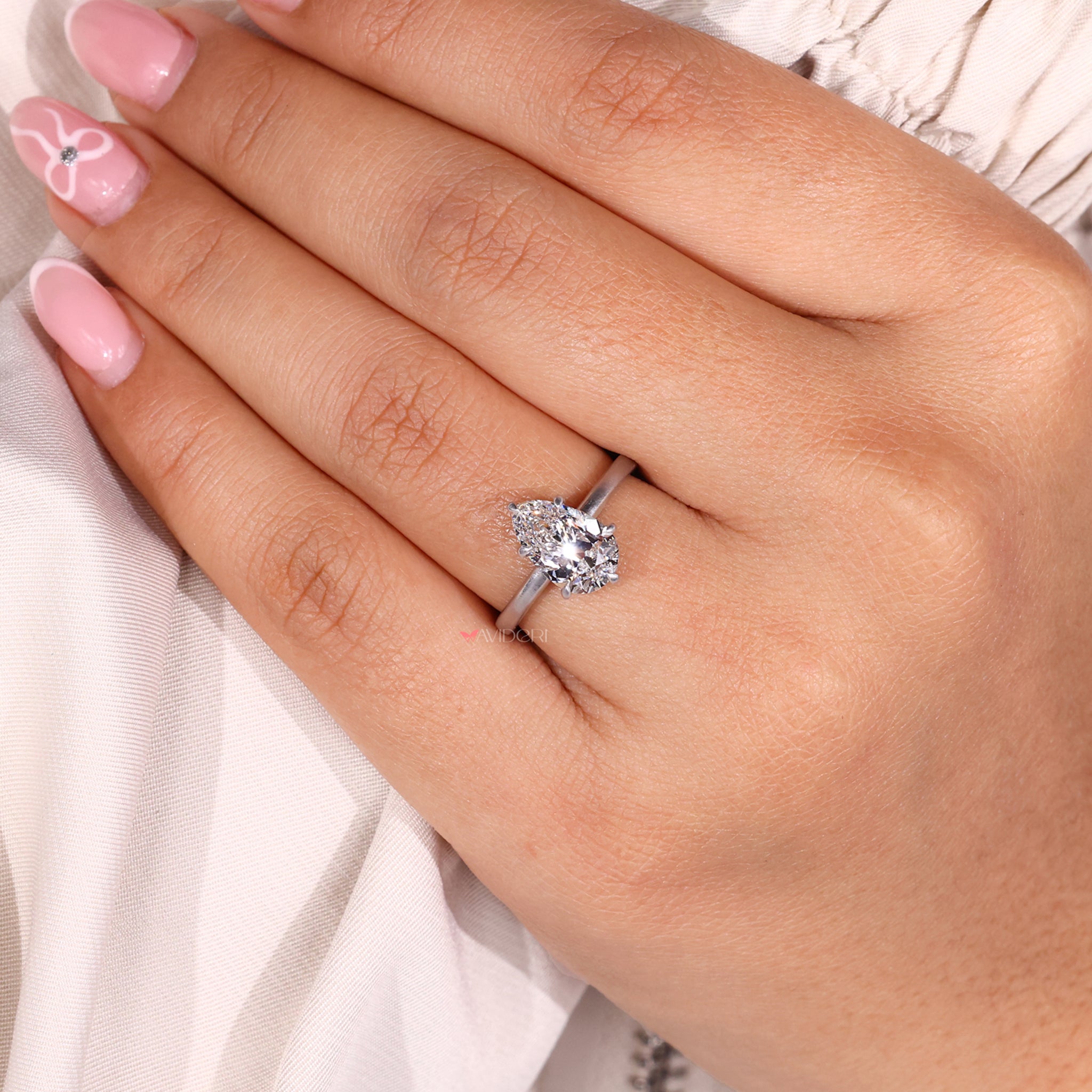 Buy engagement ring featuring a unique pear shape and sparkling diamond.
