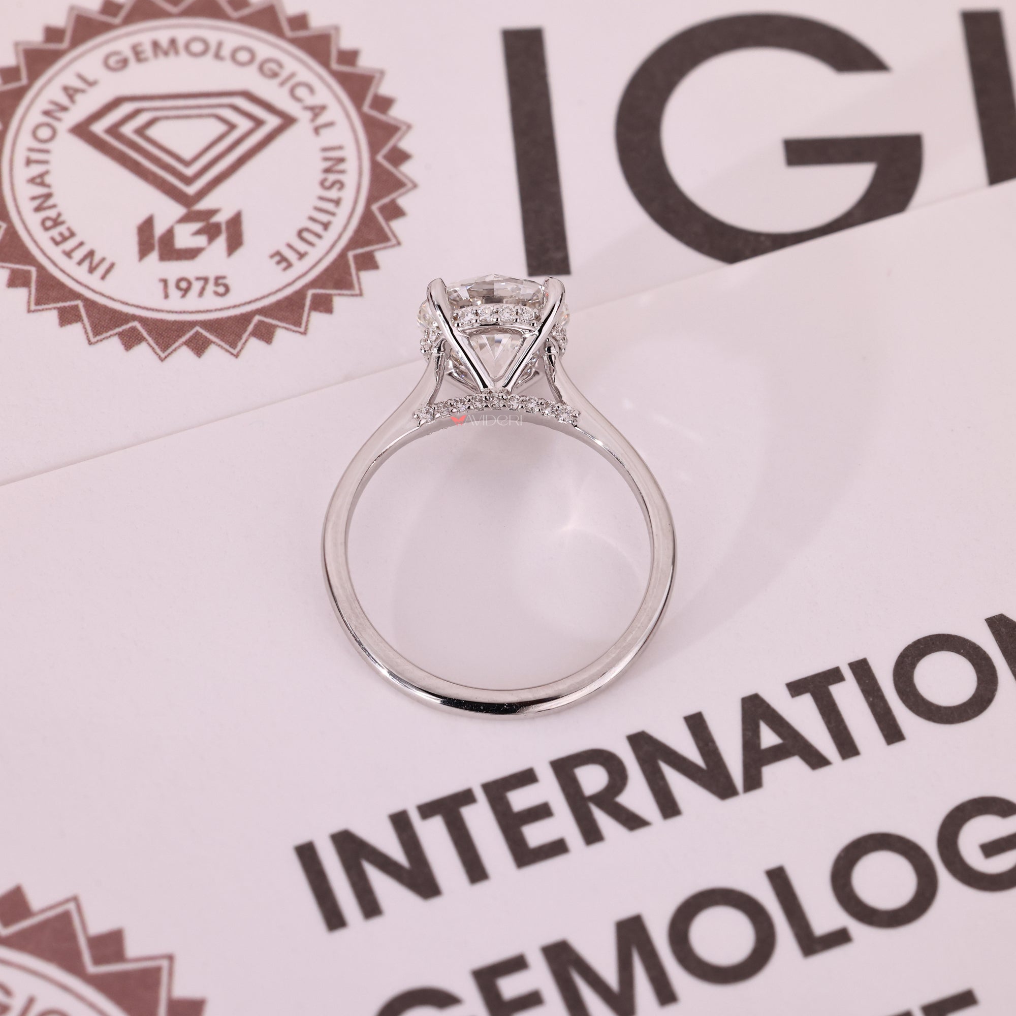 Lab grown round diamond solitaire ring with hidden accent.