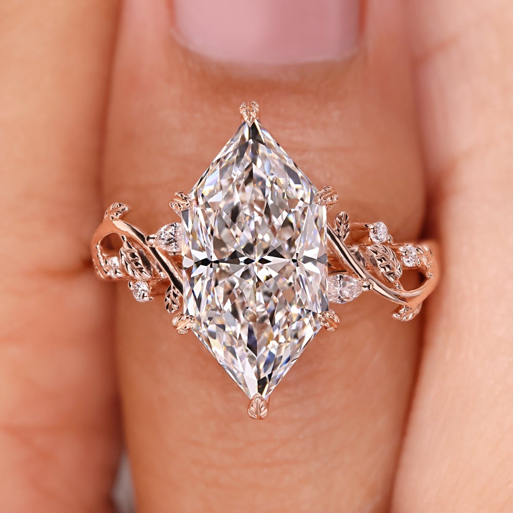 Nature inspired engagement ring with Dutch marquise diamond and leaf and vine detailing.