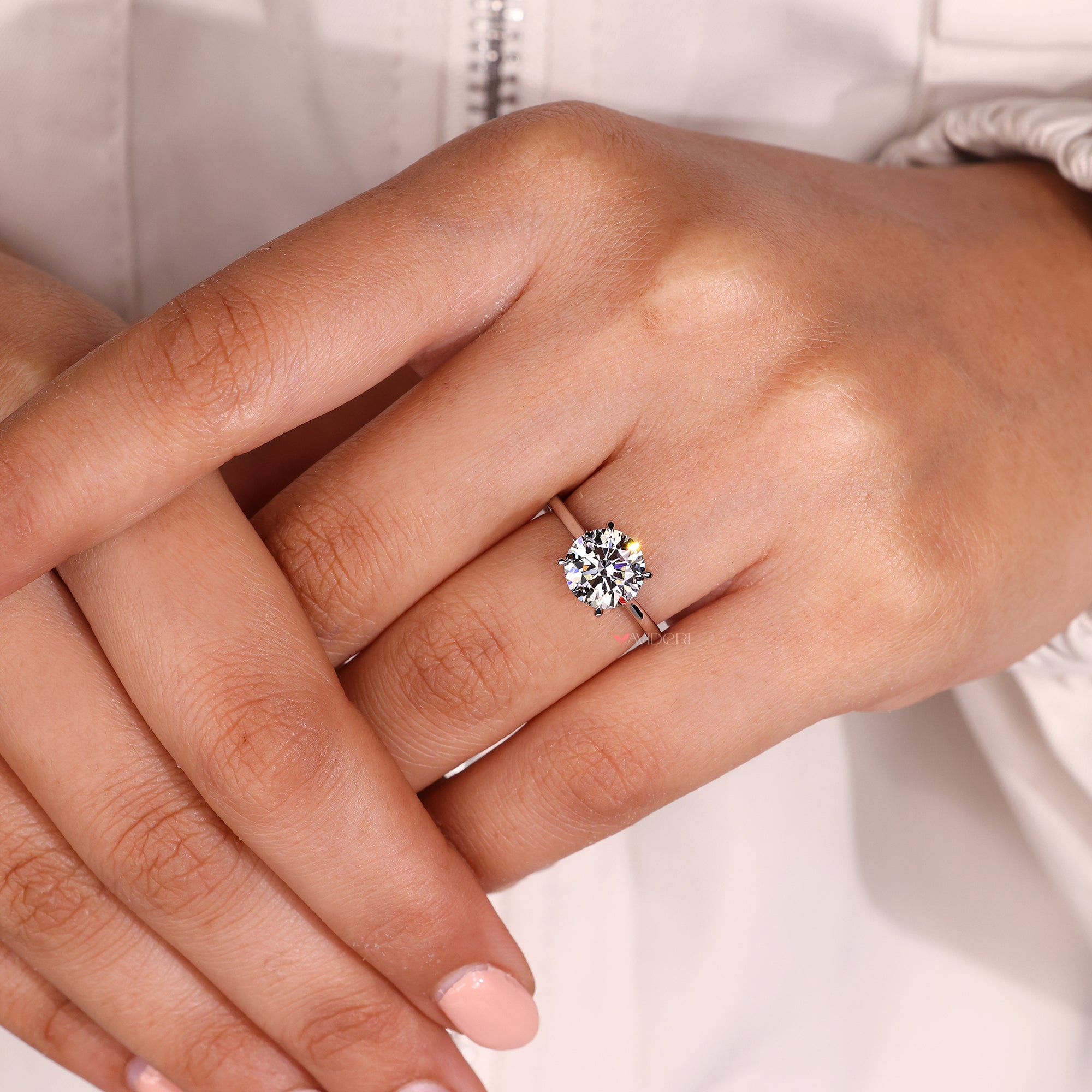 Custom engagement ring with round diamond and tapered shank.