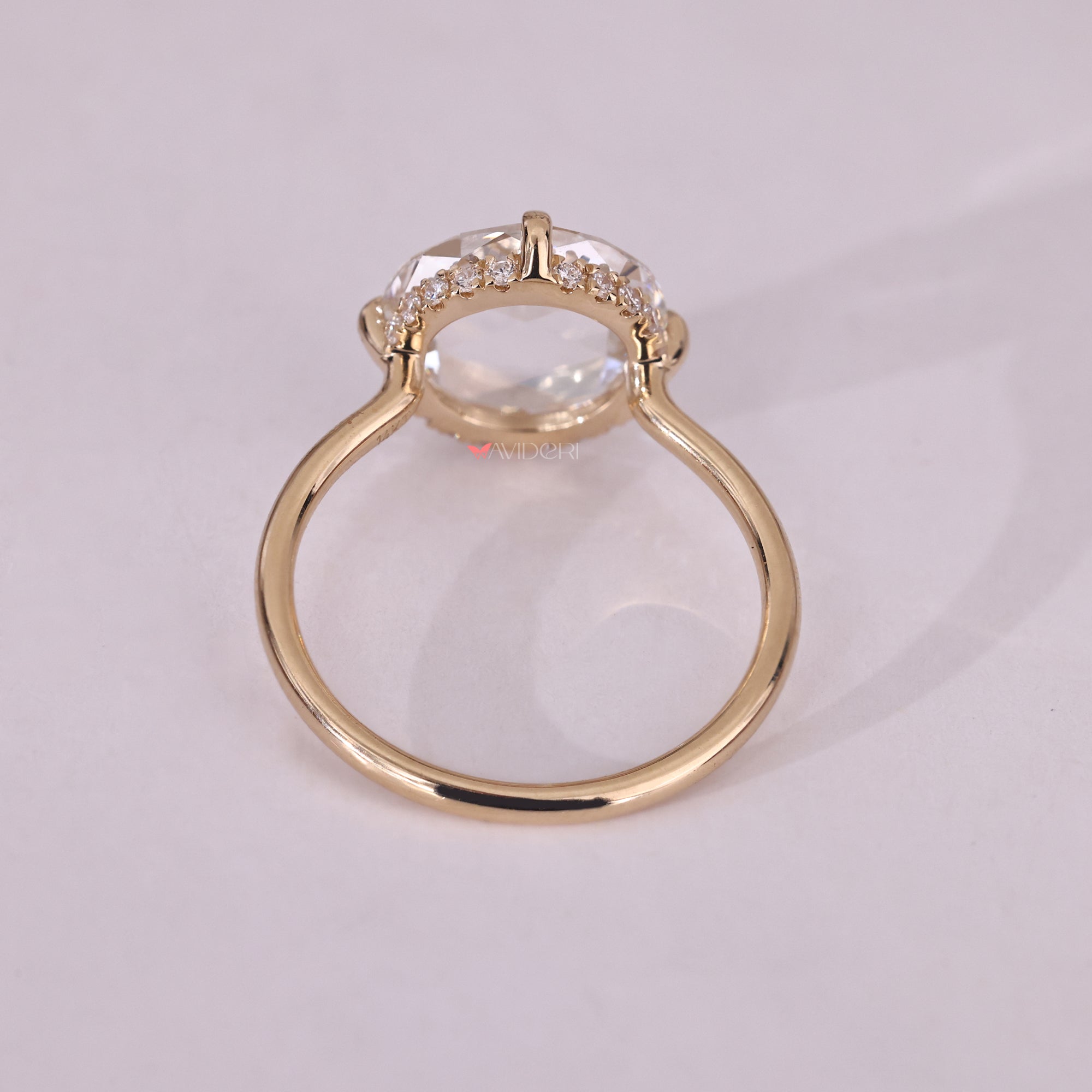 Open gallery ring featuring a round diamond, offering a unique design with visible sides.