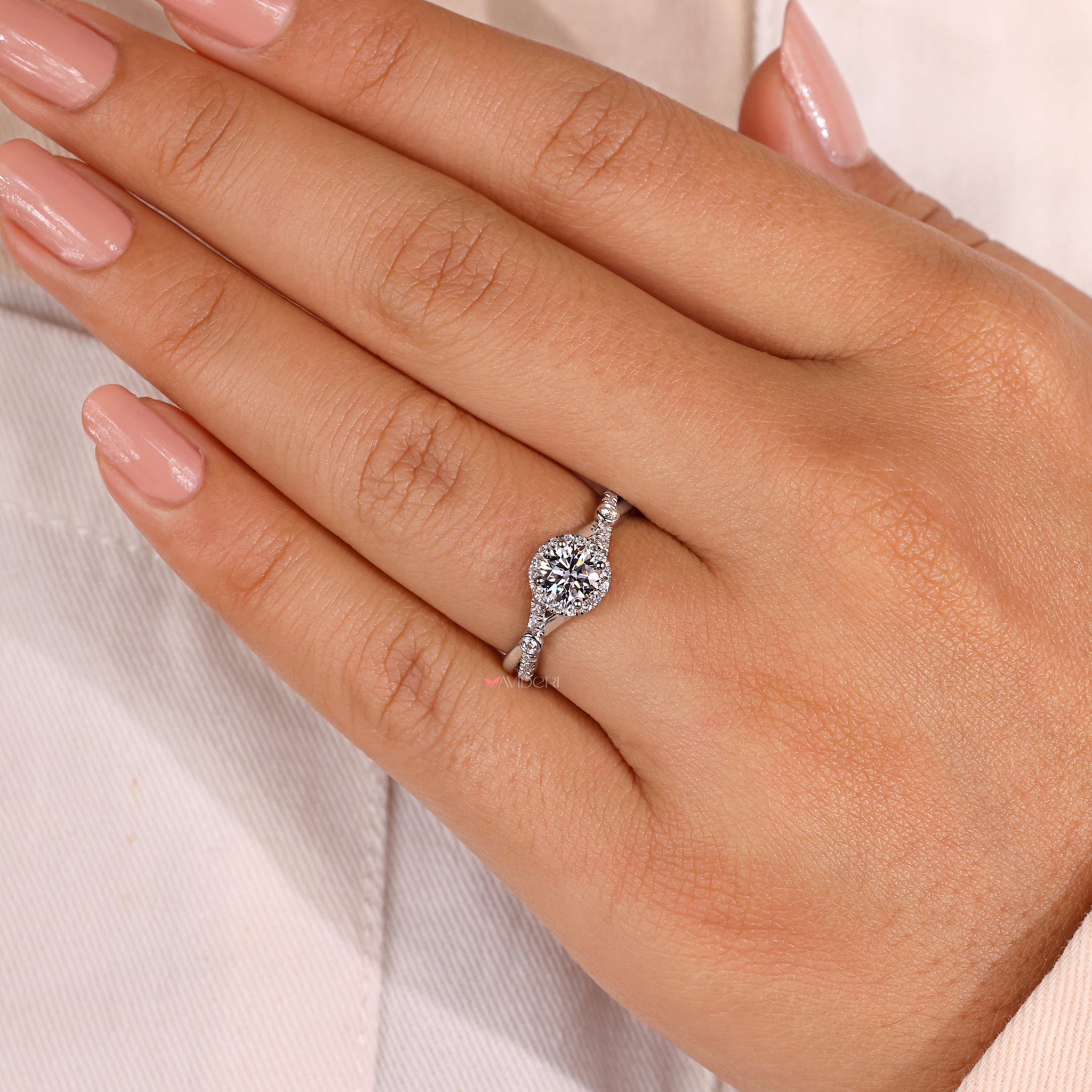 Round diamond ring with a pave diamond band.