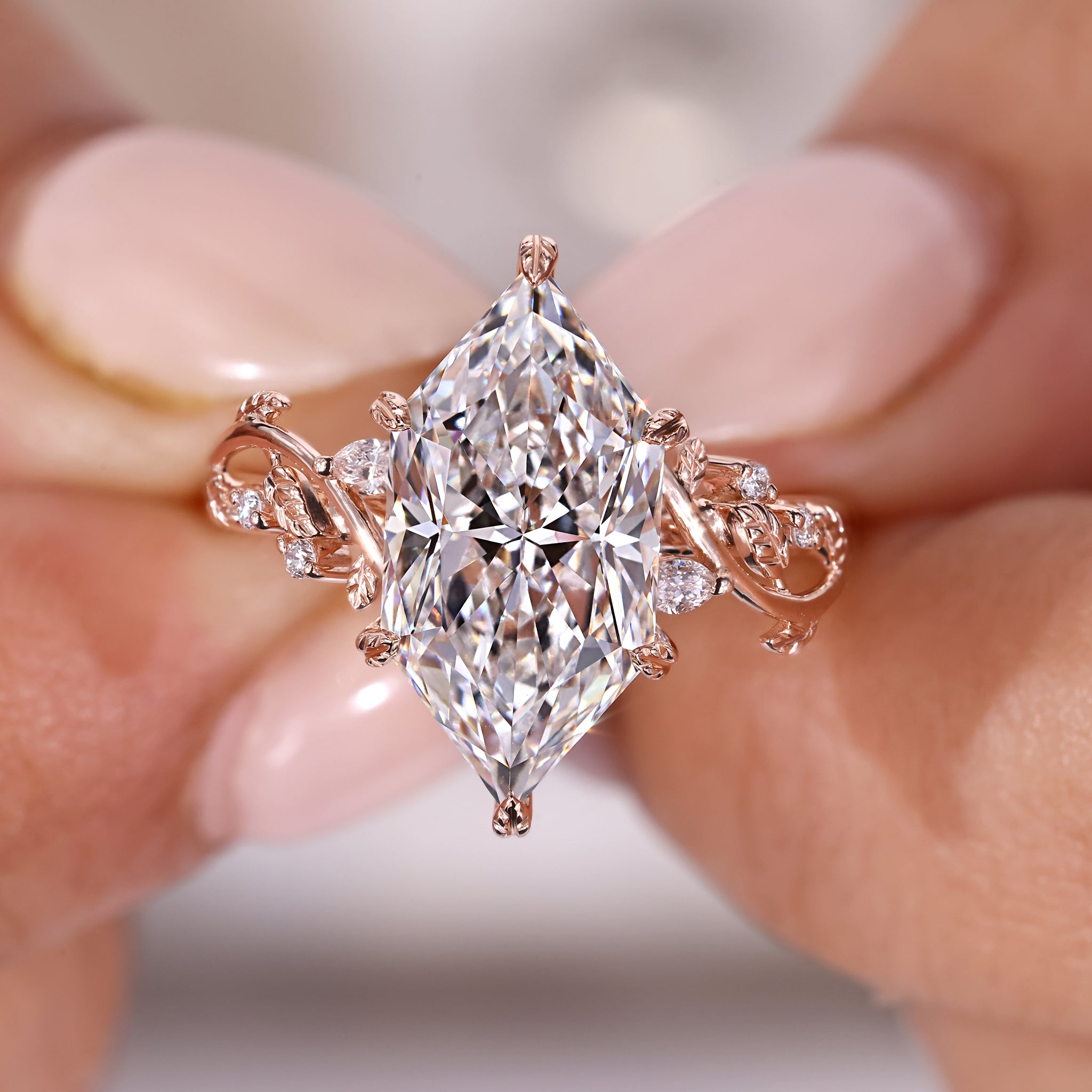 Marquise and round side stone engagement ring with handmade ring design.