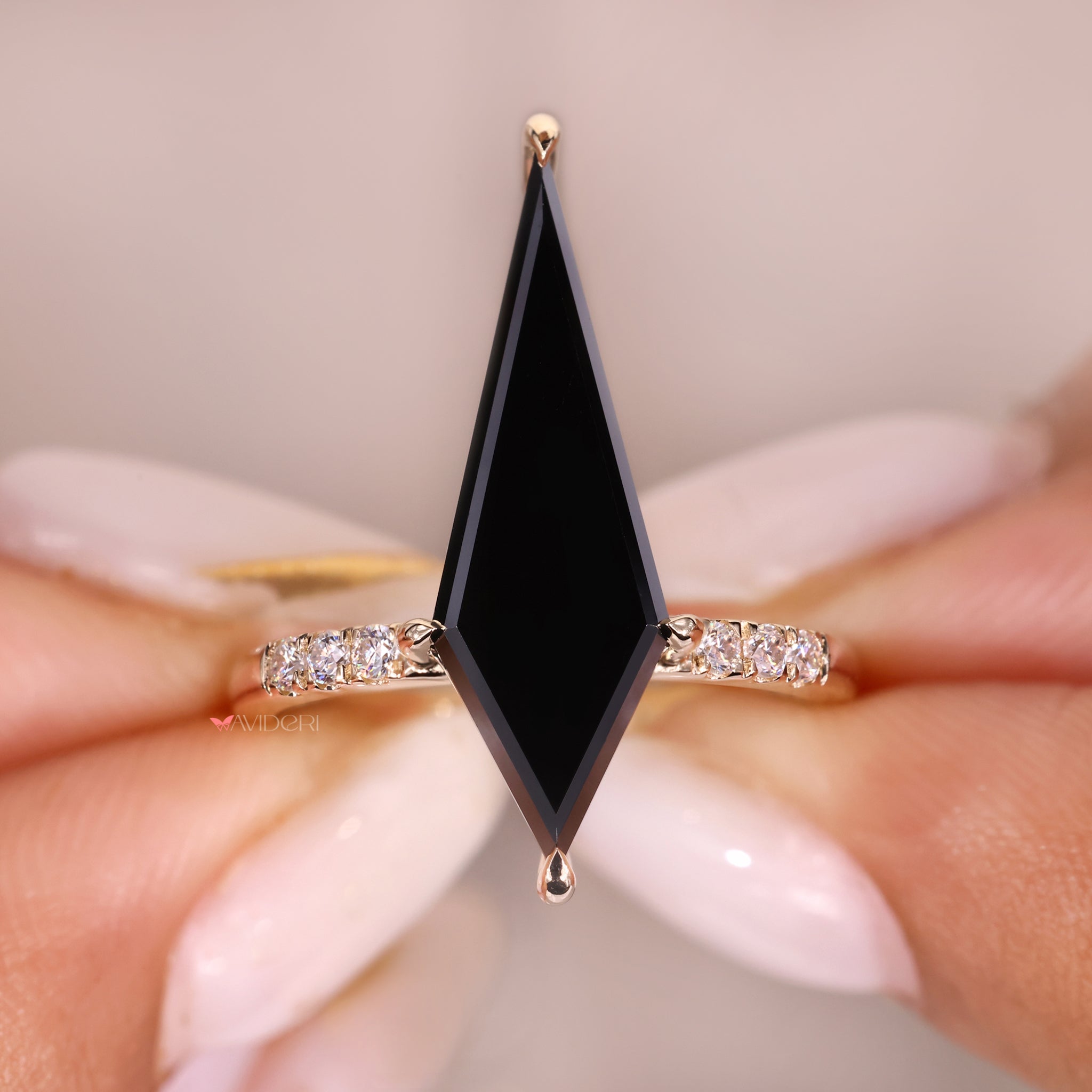 Claw prong ring holding a black moissanite in a bold design.