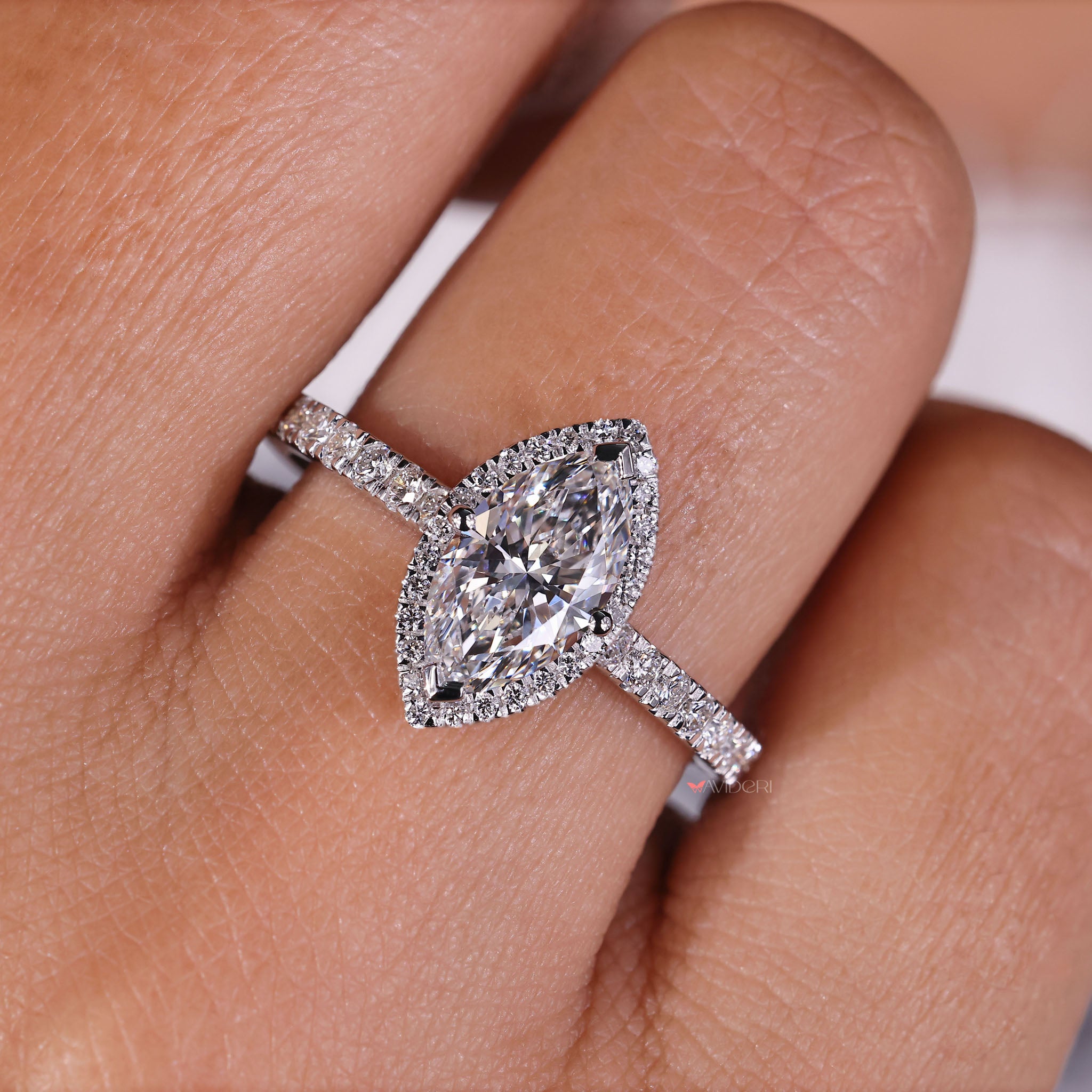 Stunning marquise diamond with halo design, radiating beauty and charm in a unique jewelry piece.