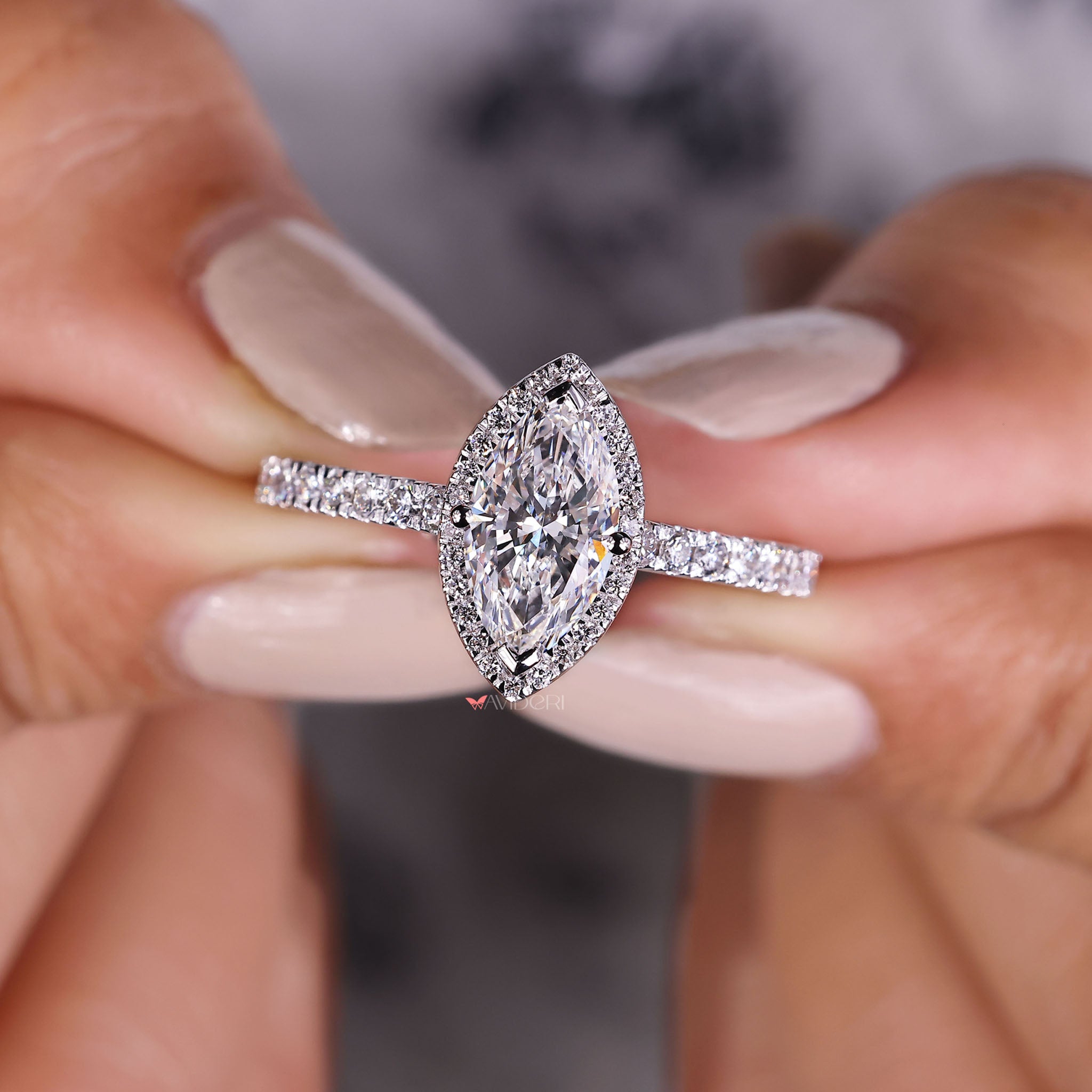 Classic marquise ring with halo, perfect for adding a touch of elegance to any engagement or celebration.