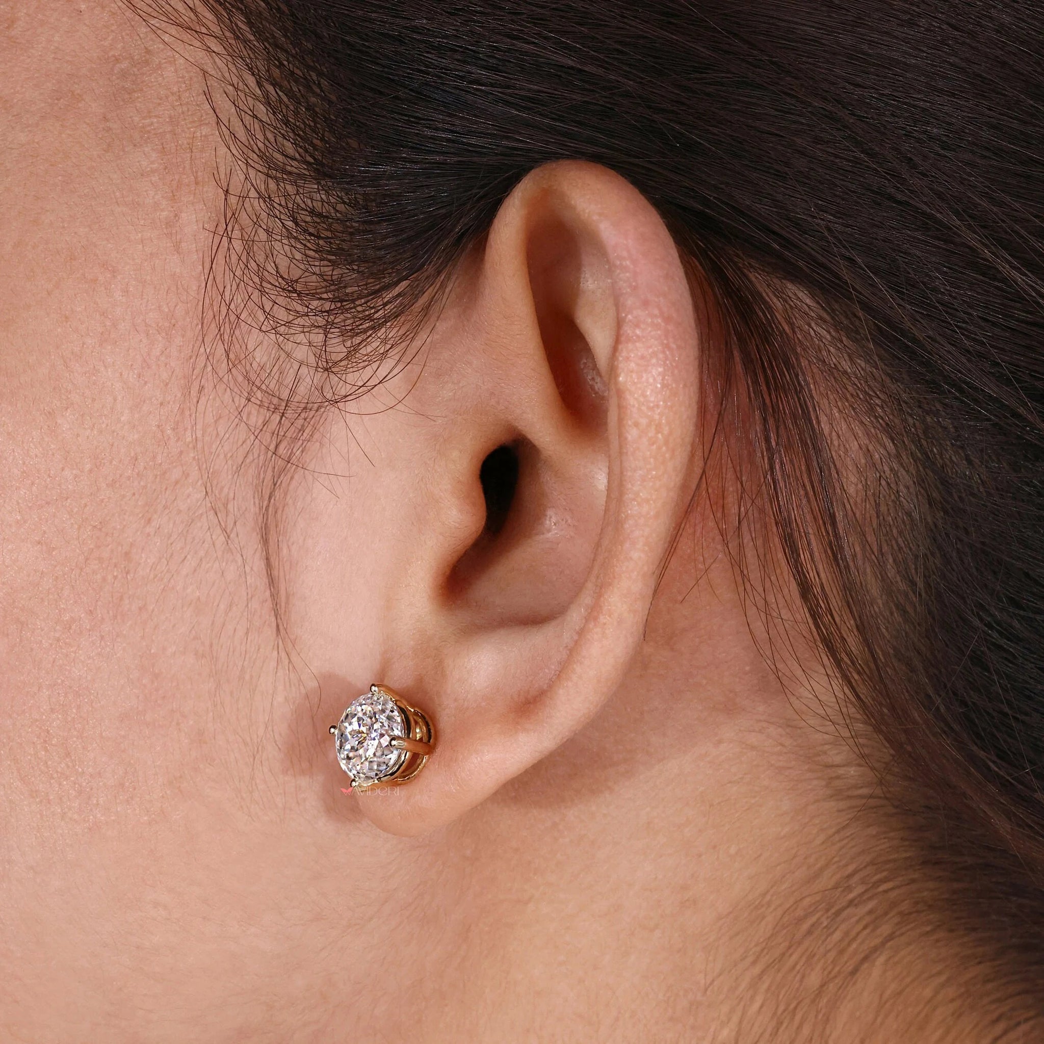 Moissanite stud earrings with yellow gold settings for a luxurious touch.