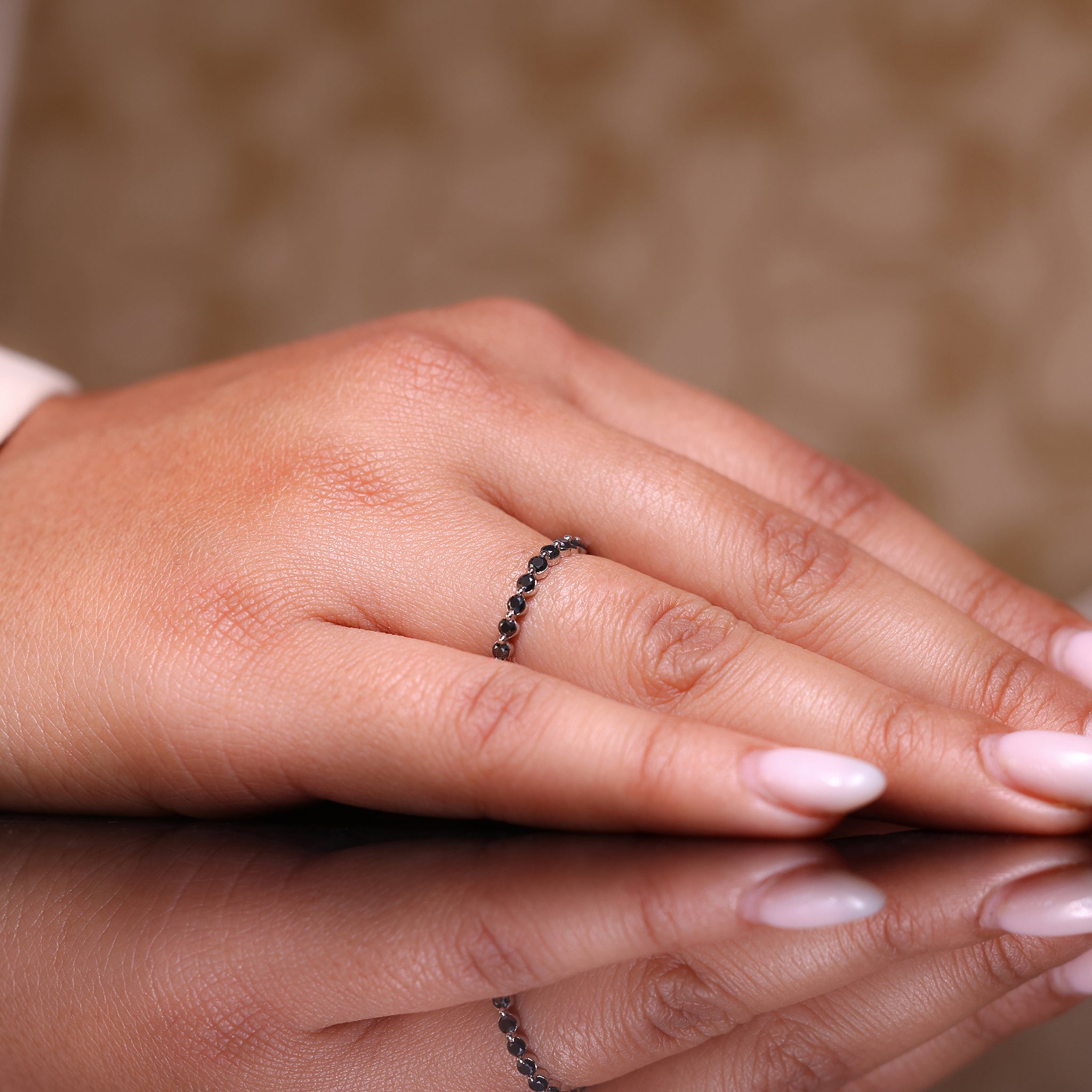 Shared prong wedding band featuring a moissanite eternity band design.