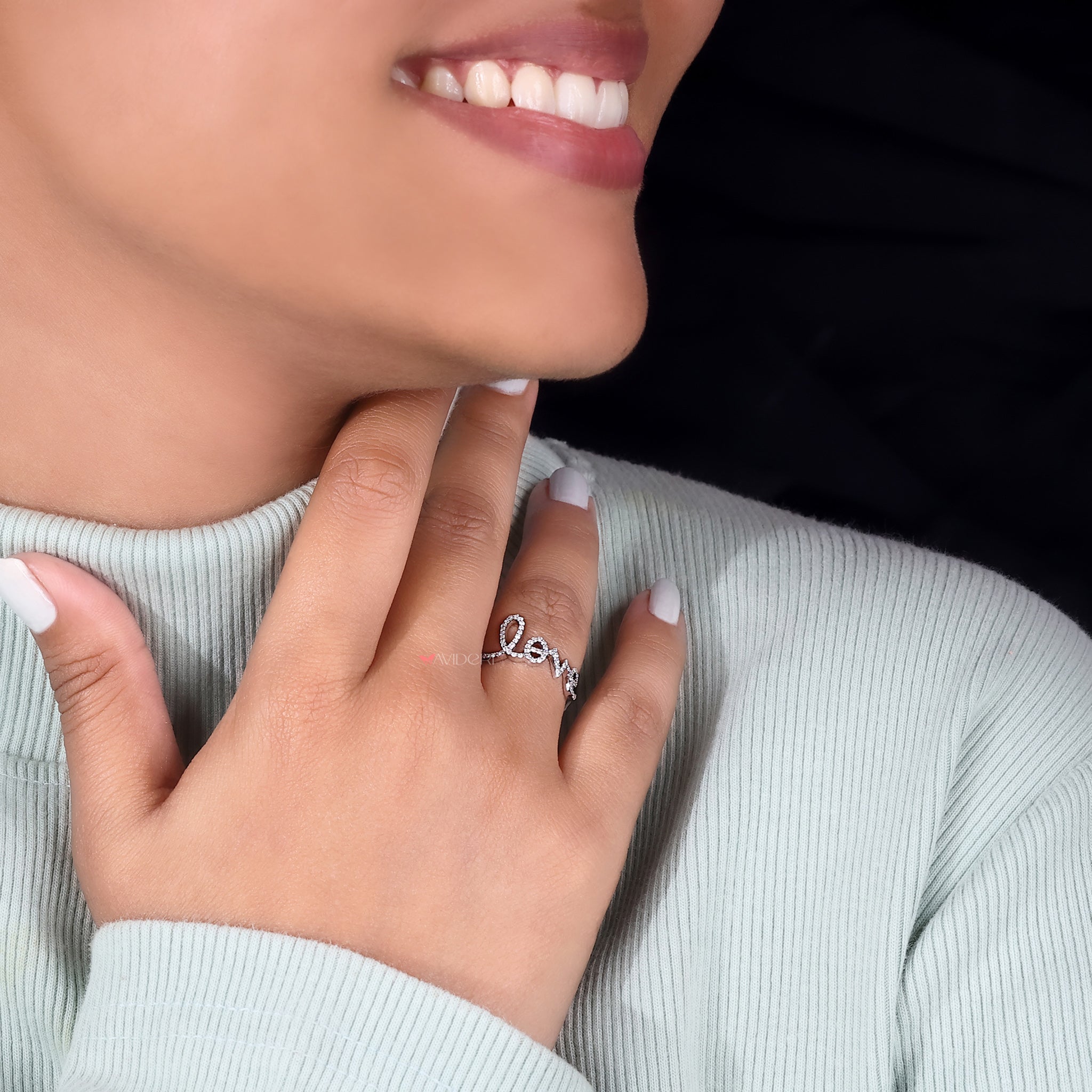 The avideri ring lies beside an open ring box.