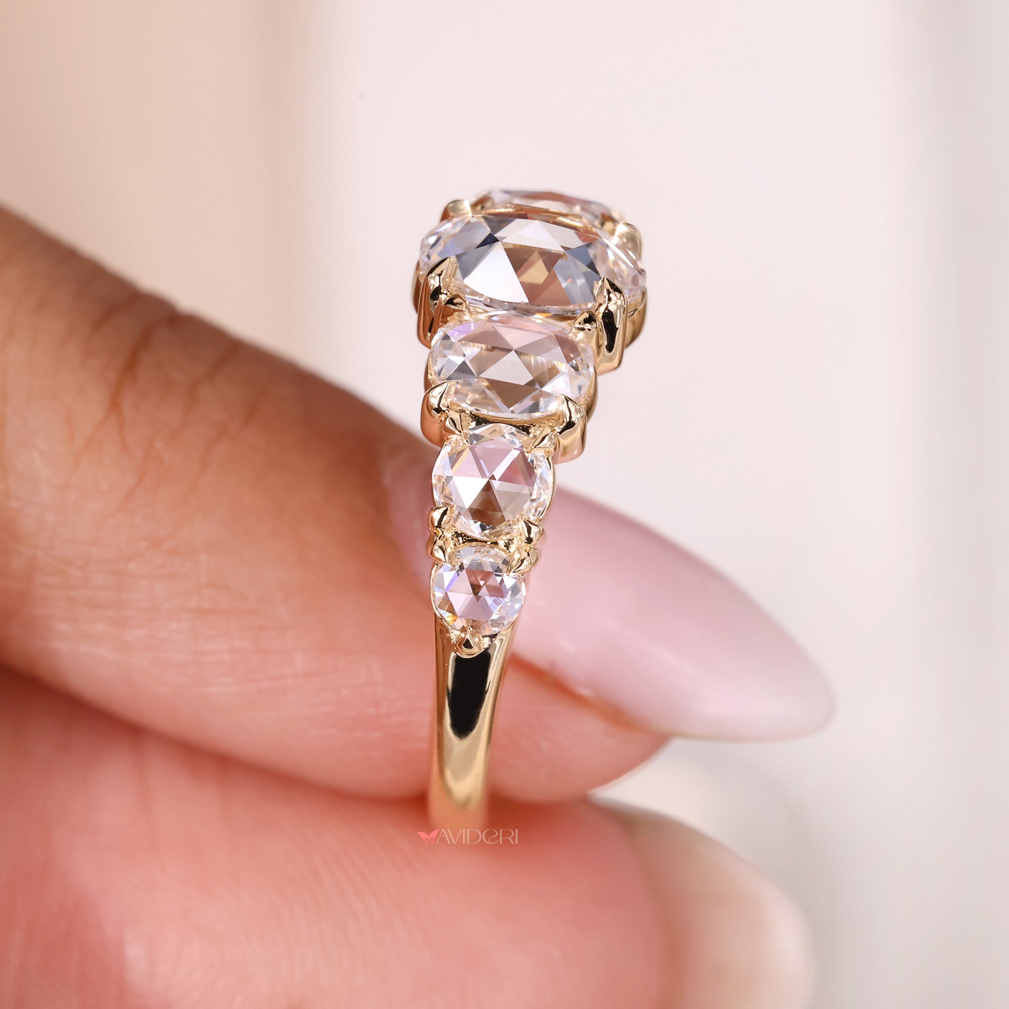 Yellow gold diamond band with oval diamonds for an elegant wedding band.