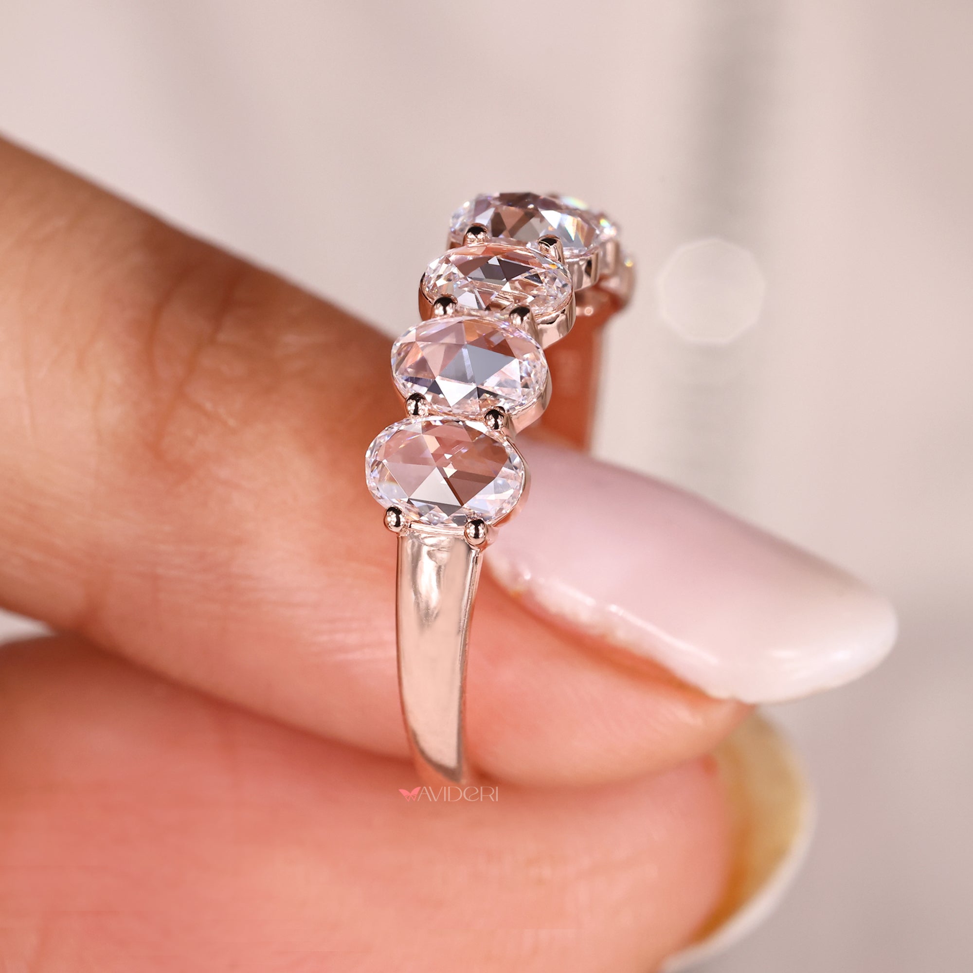 Custom rose gold wedding band with oval rose cut diamonds.