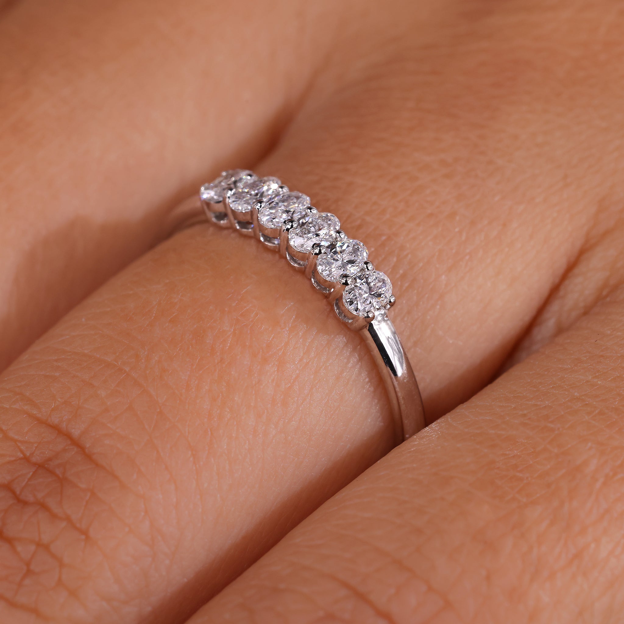 A six stone ring set in a sleek modern design.