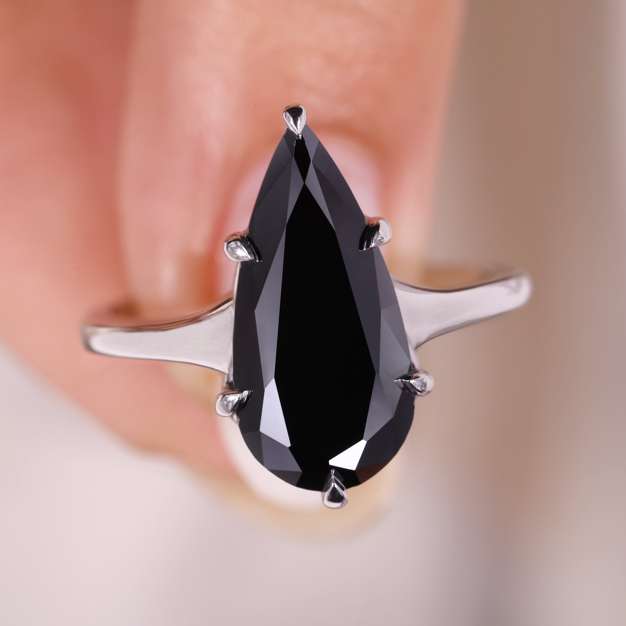 Teardrop Shaped Moissanite Ring set in a polished white gold band.