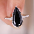 Teardrop Shaped Moissanite Ring set in a polished white gold band.