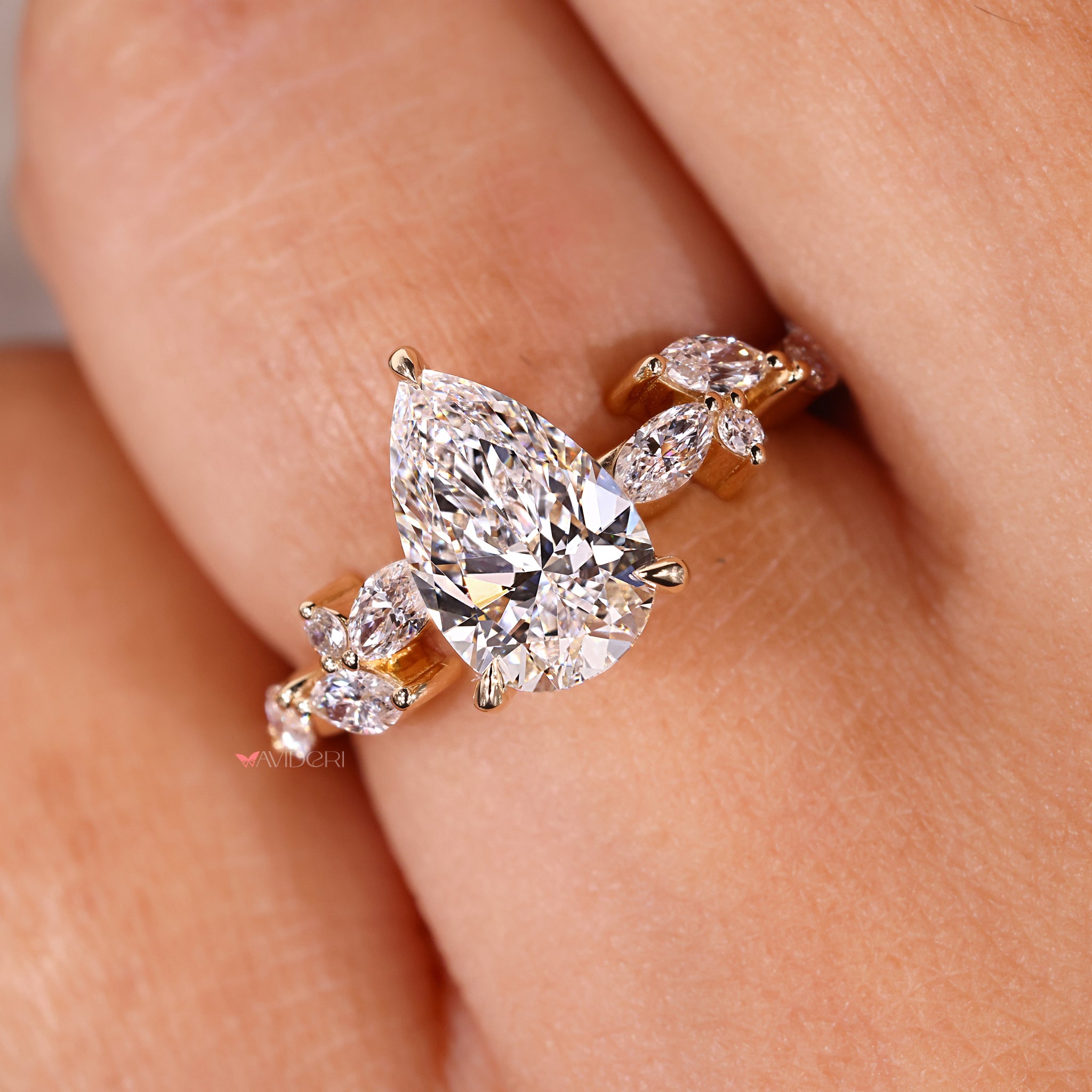 Prong setting engagement ring featuring a pear diamond and custom handmade finish.
