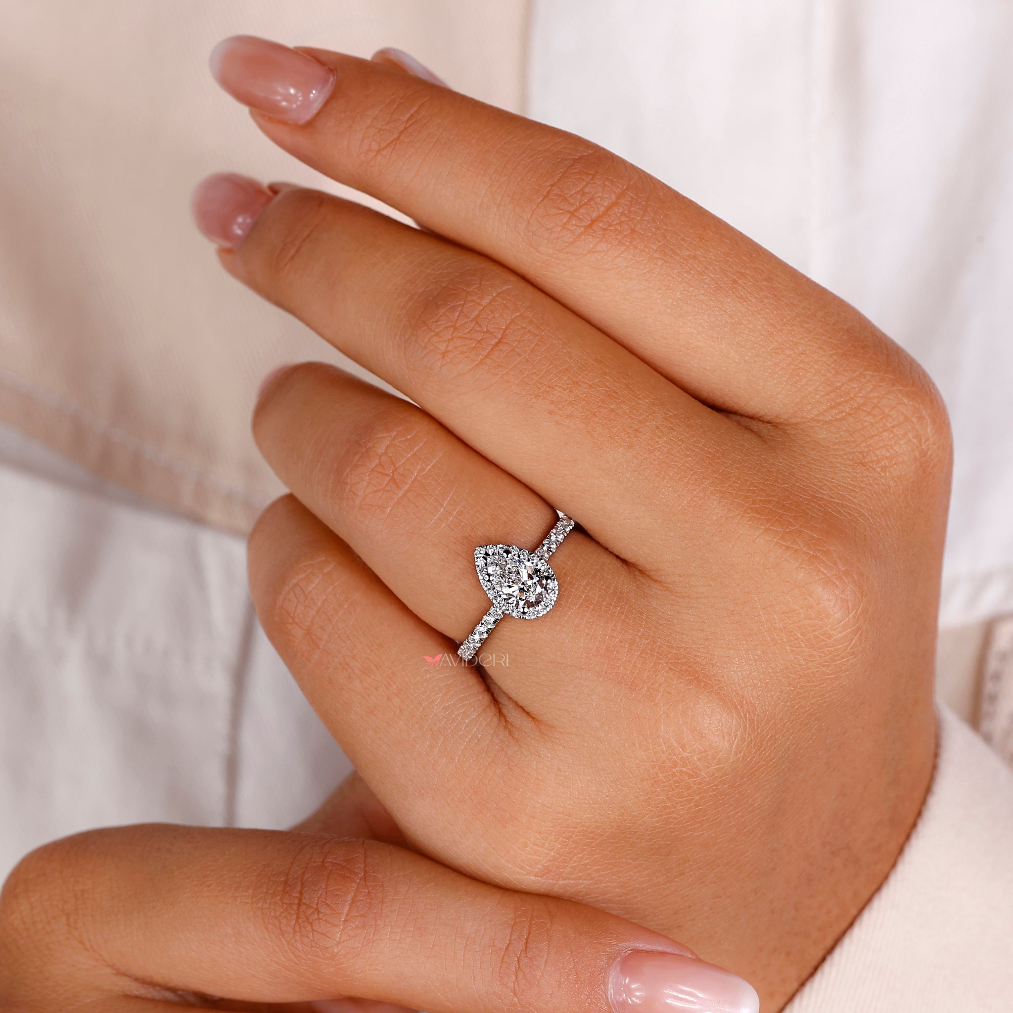 Classic pear and round diamond ring with a luxurious and dazzling appeal.