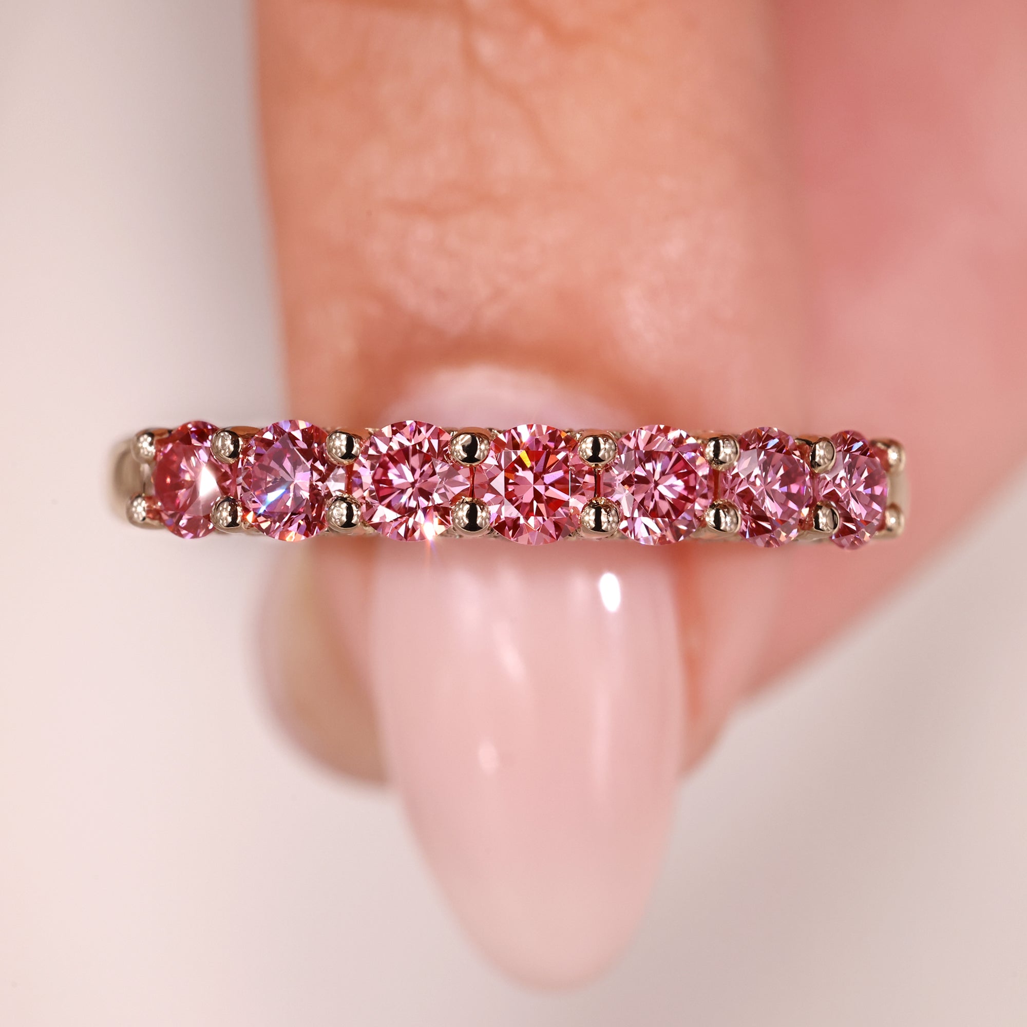 Diamond half eternity band in shared prong setting.