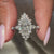 custom white gold engagement ring with round cut diamonds and distance pave band.