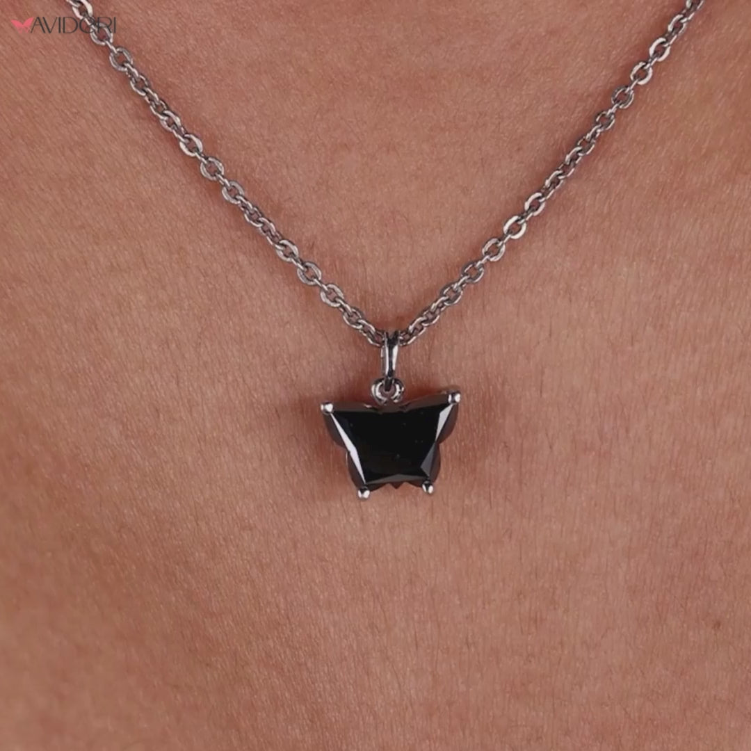 Moissanite pendant set in a gold butterfly pendant for an eye-catching piece