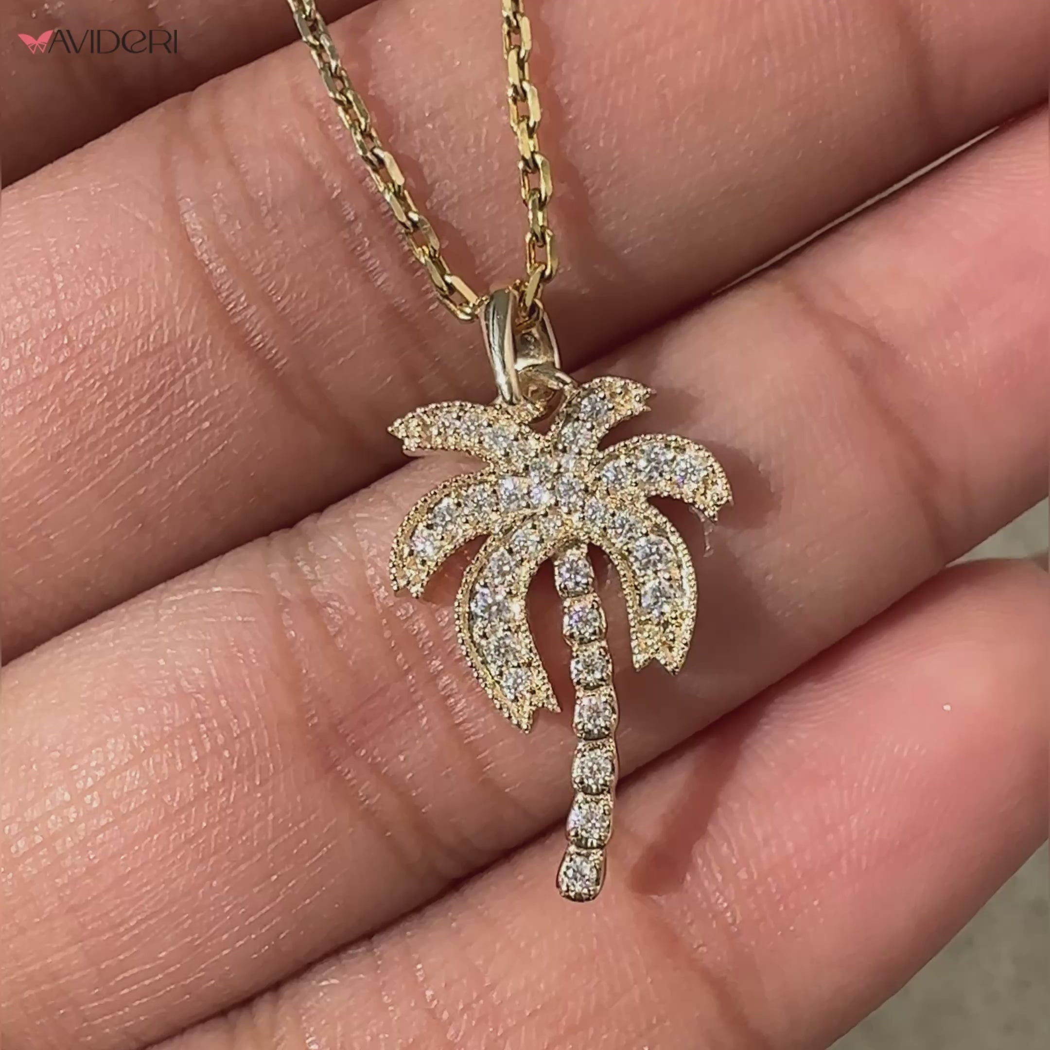 Gold palm tree pendant featuring intricate details.