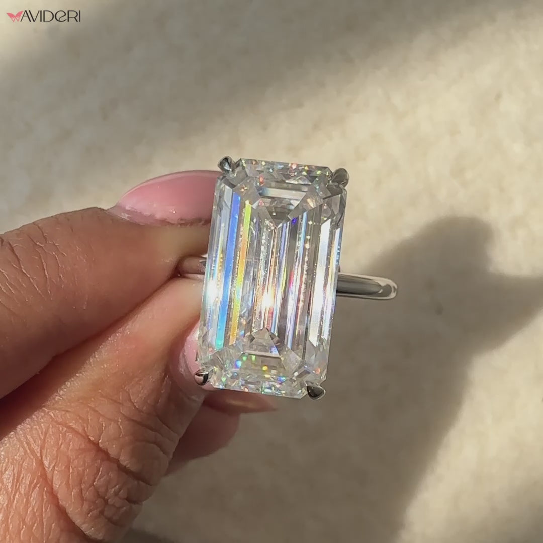 Big moissanite ring featuring an emerald cut moissanite stone.