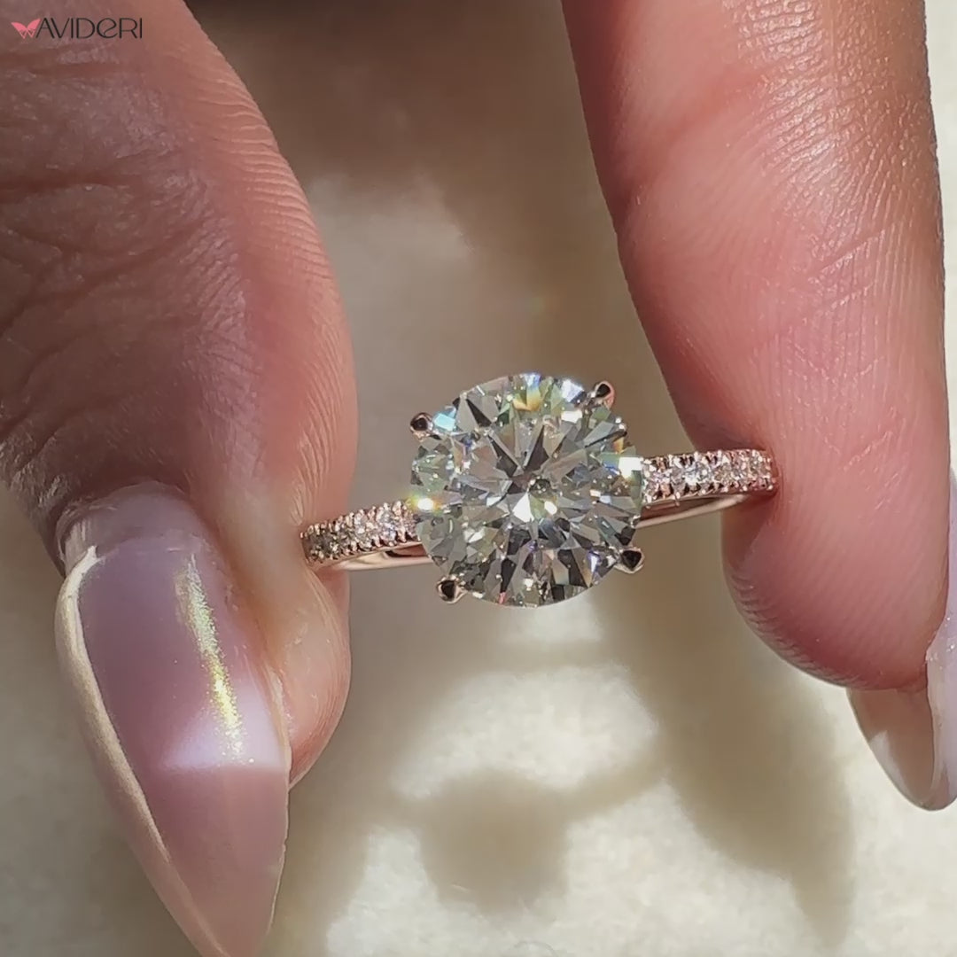 Rose gold engagement ring featuring round cut diamond engagement ring and open gallery ring.