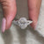 Custom engagement ring placed with handmade jewelry.