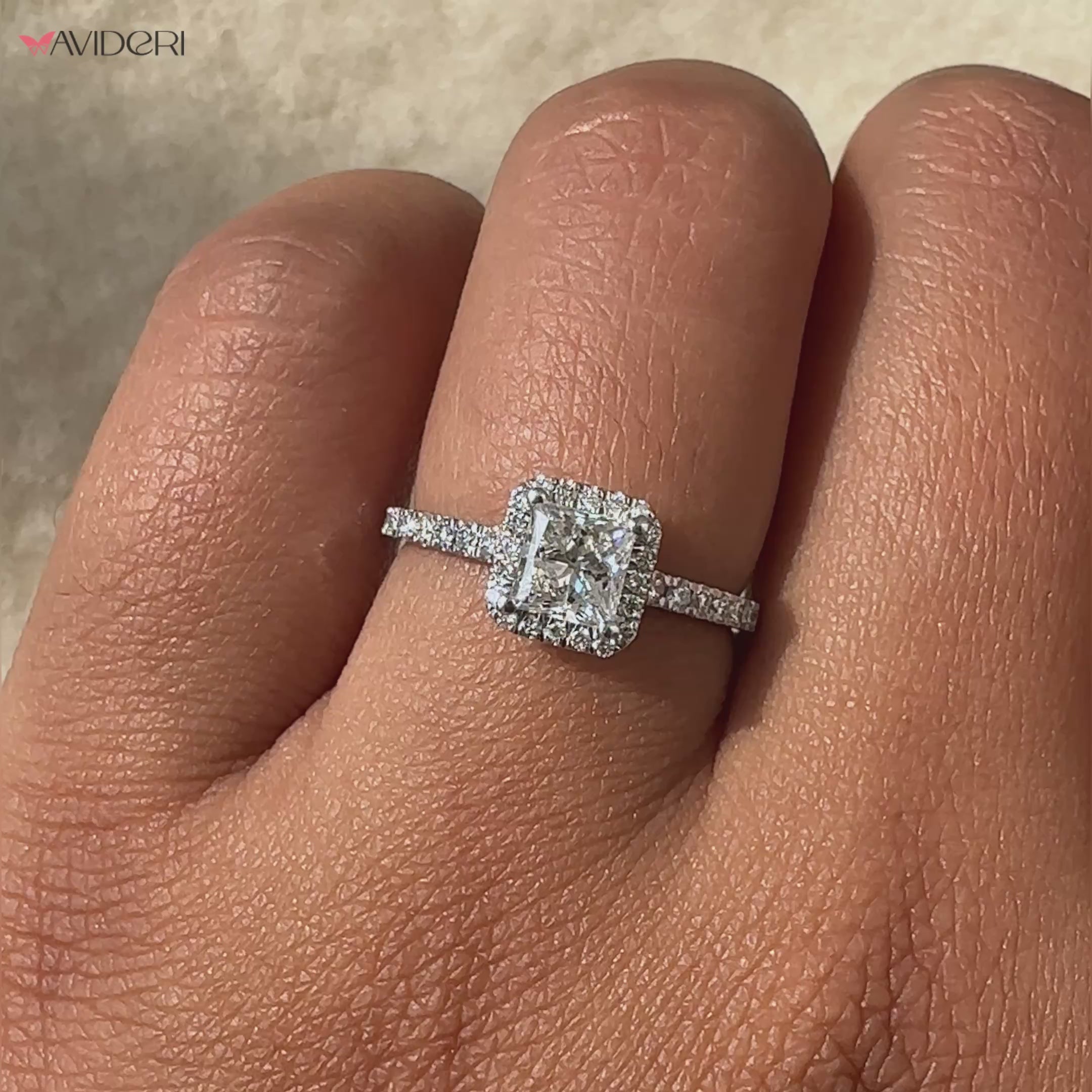 Princess cut halo engagement ring with a dazzling halo of diamonds, crafted for a classic and modern style.