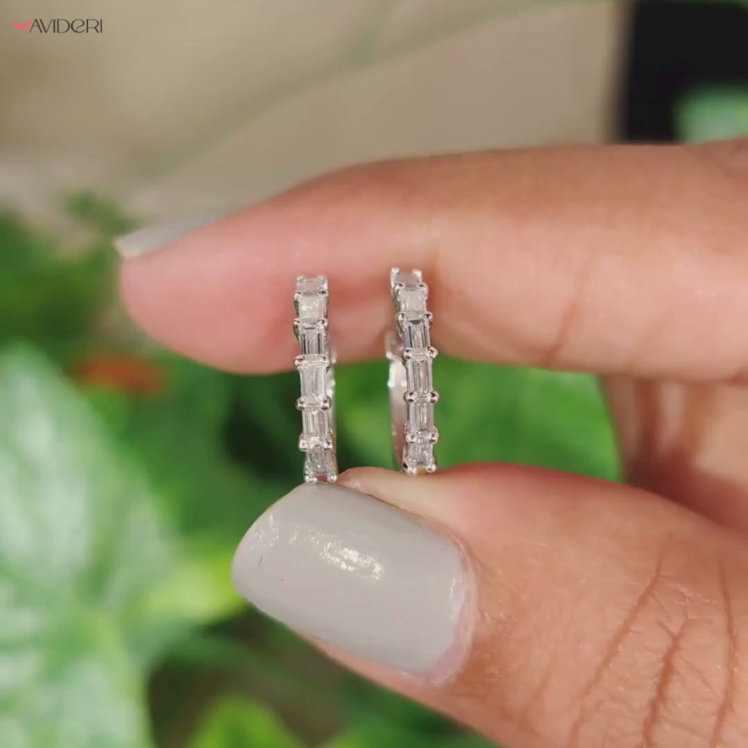 Pair of white gold hoop diamond earrings on display