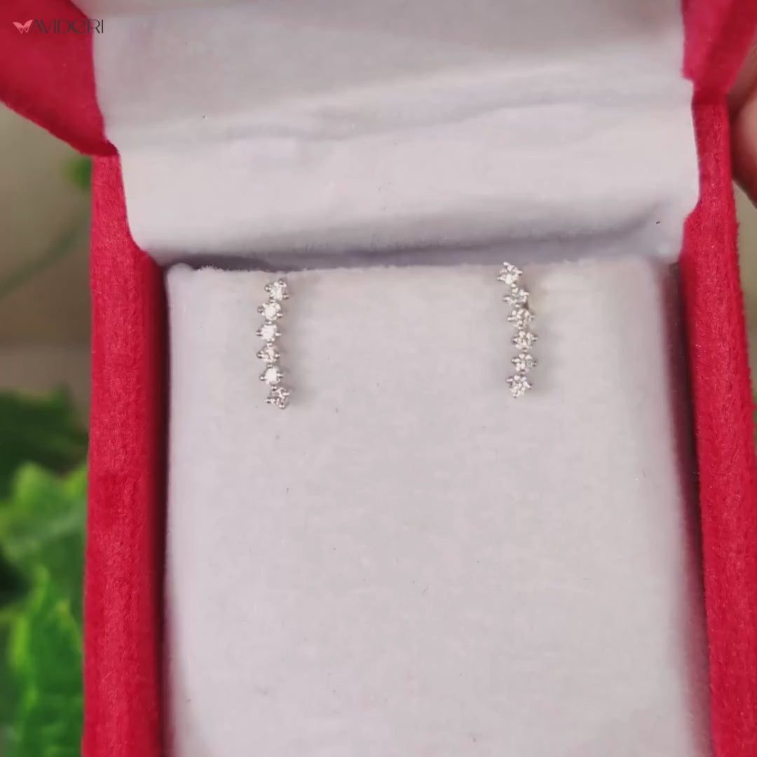 Close-up of crawler stud earrings featuring sparkling diamonds.