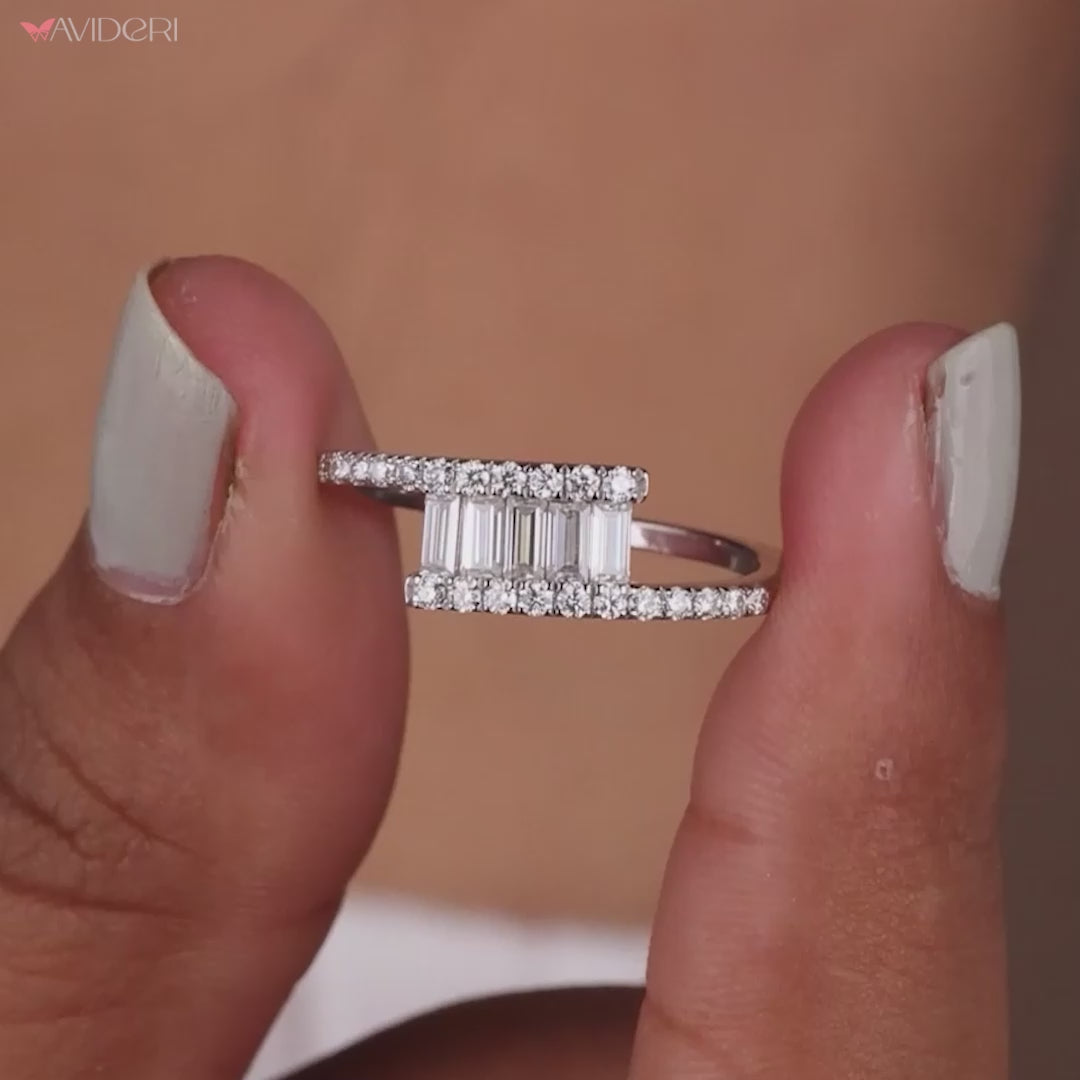 A ring with round side stones beside a center gem.