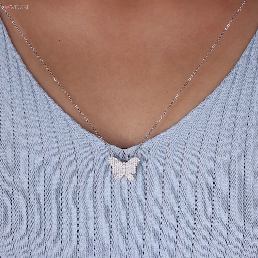 Round diamond pendant shaped in a butterfly design