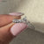Elegant pear and round diamond band for a timeless look.