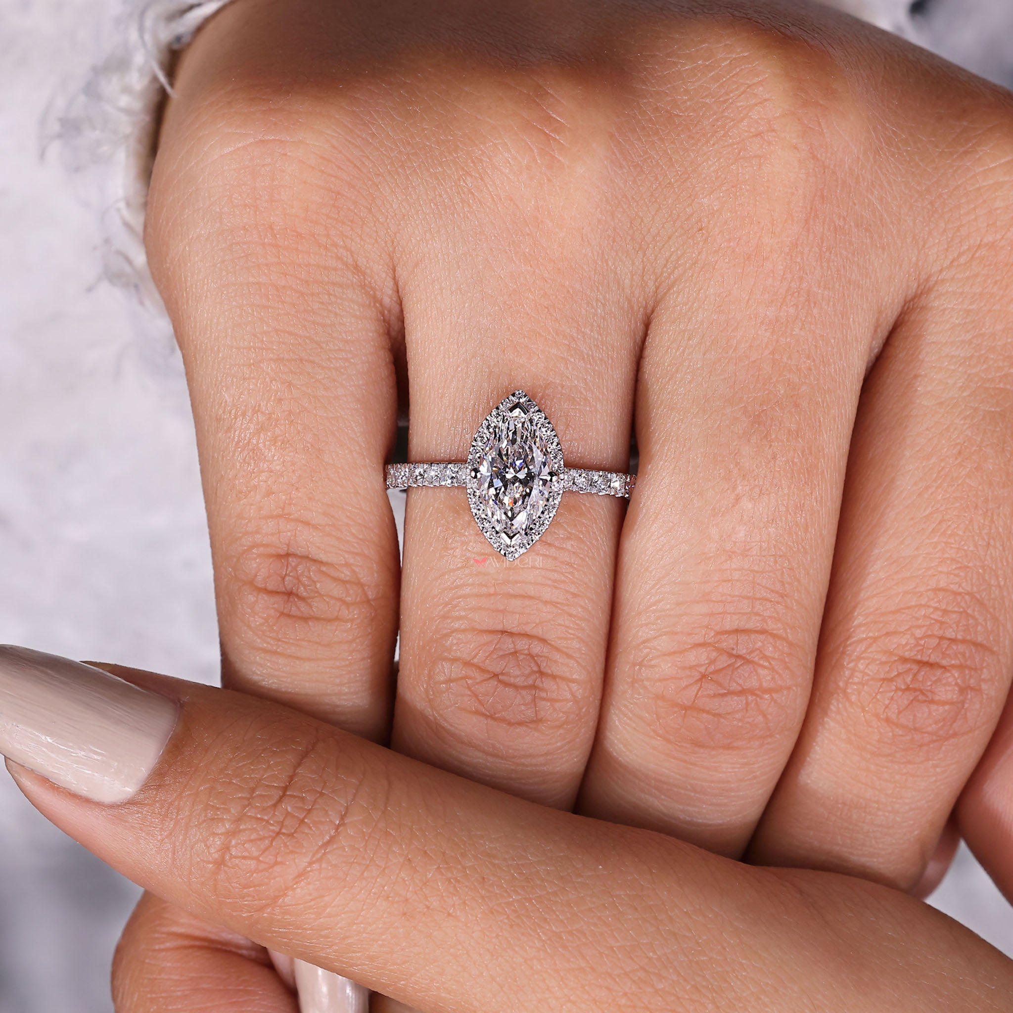 Sophisticated halo marquise engagement ring, blending traditional style with modern elegance for a unique look.