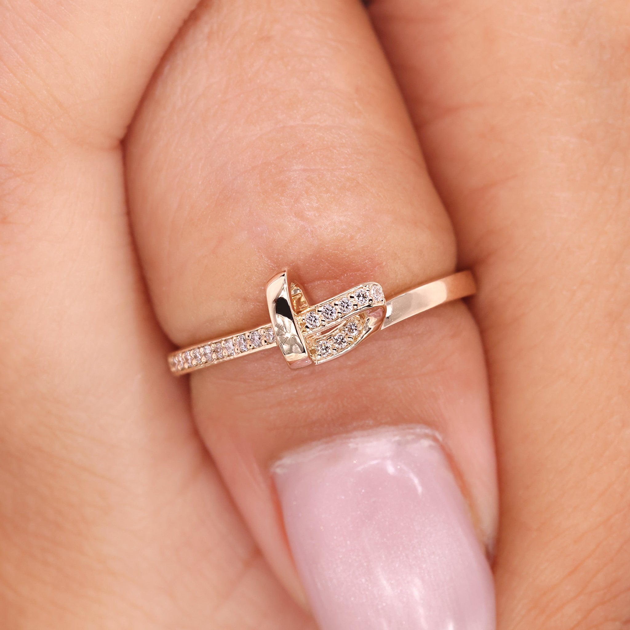 Heart shaped band made with delicate knot design and diamond accents.