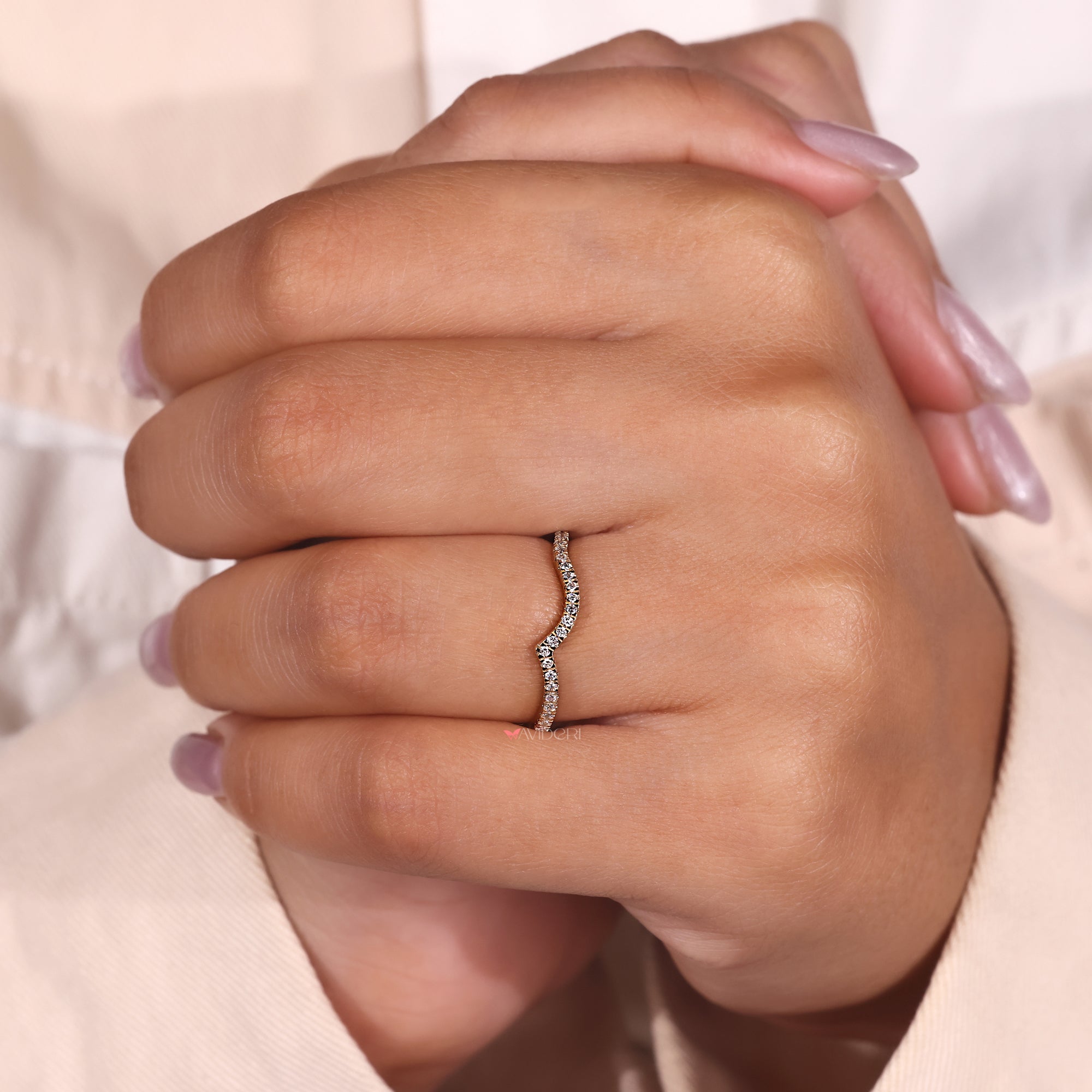 Curvy diamond band with a smooth, flowing design, set with sparkling diamonds.