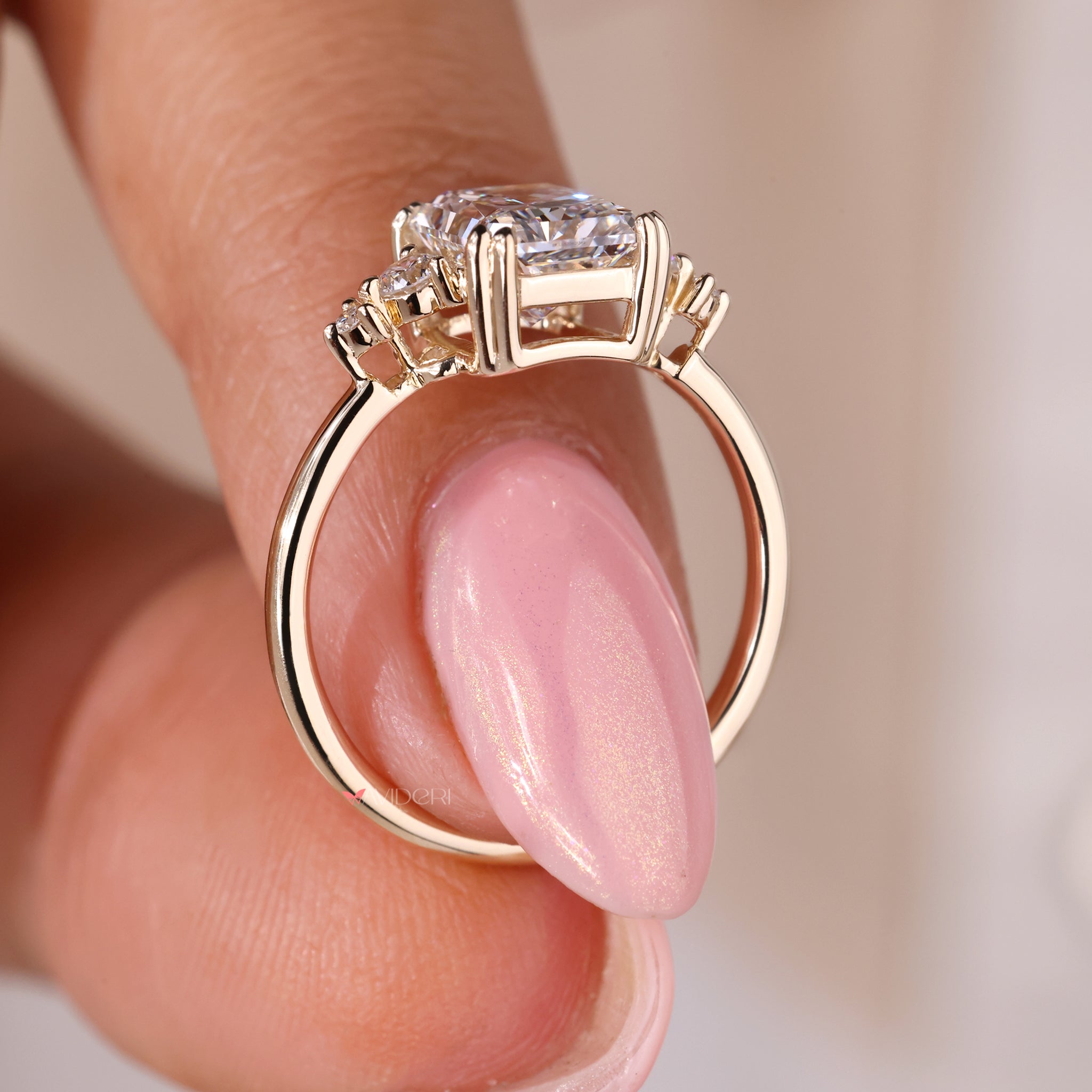 Yellow gold 5 diamond ring featuring a radiant cut diamond for added sparkle.