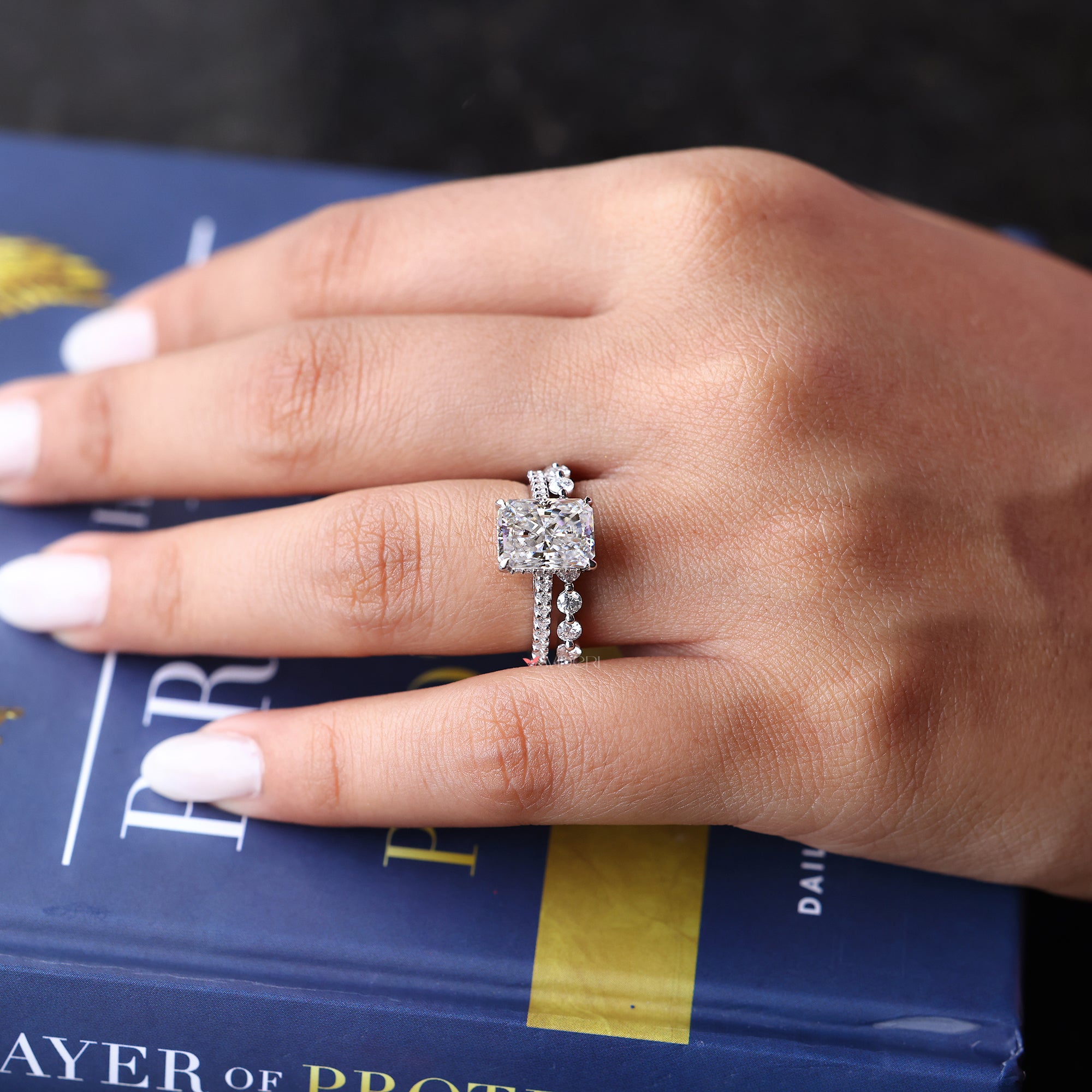 Radiant cut moissanite engagement ring and wedding band set.